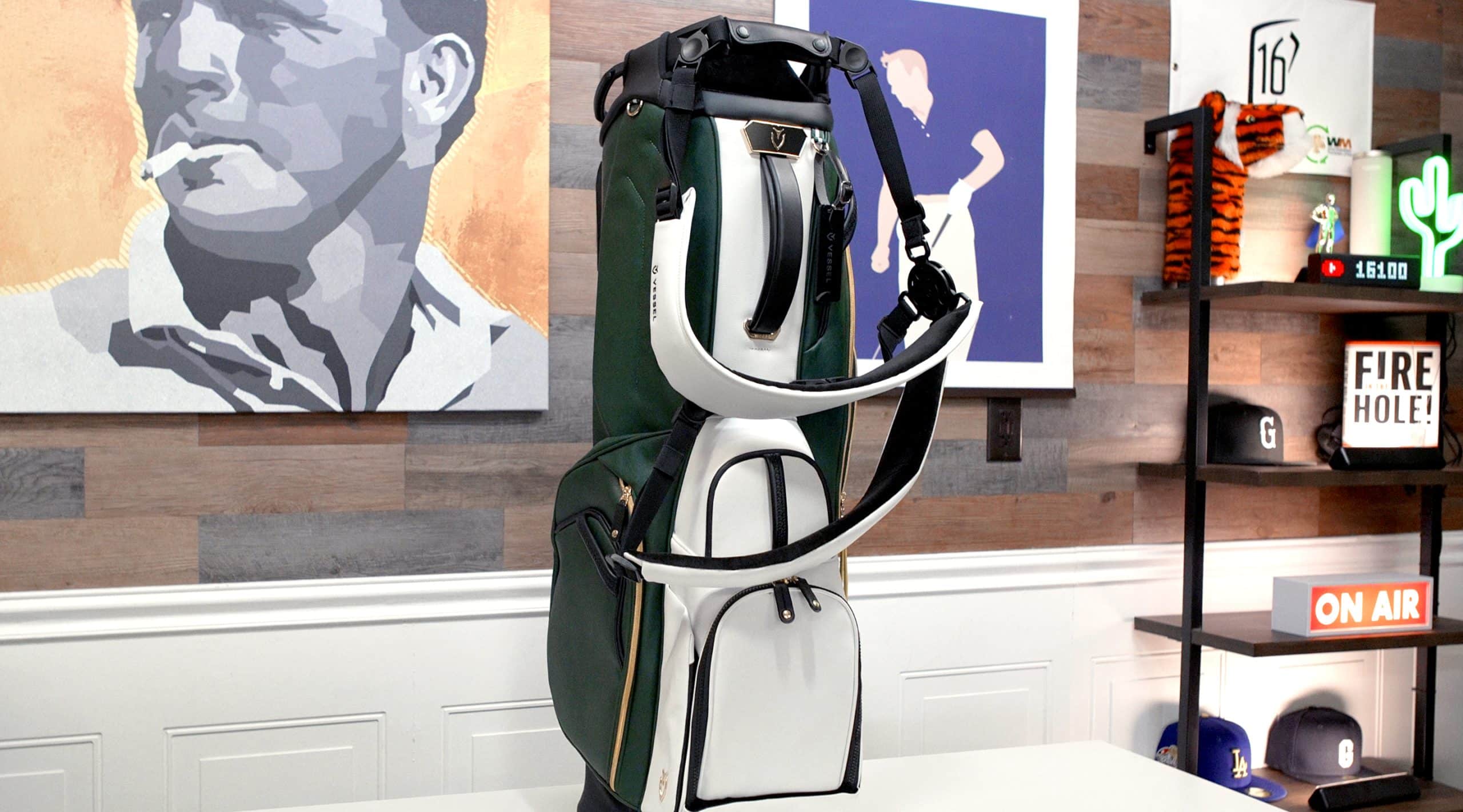 Green and white golf bag on display table