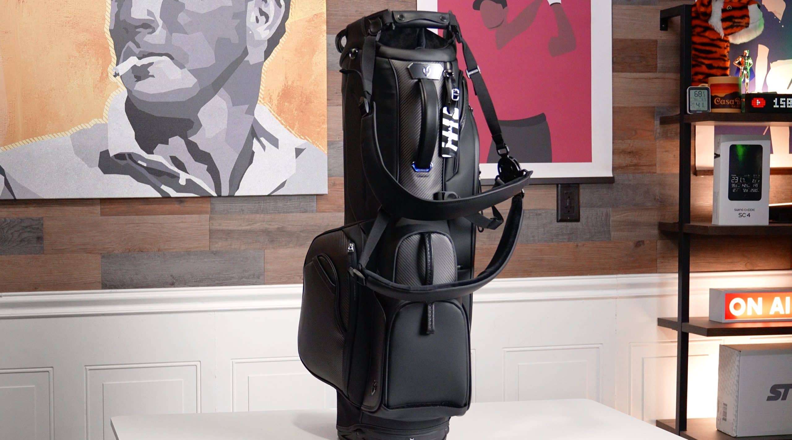 Black golf bag on display table indoors