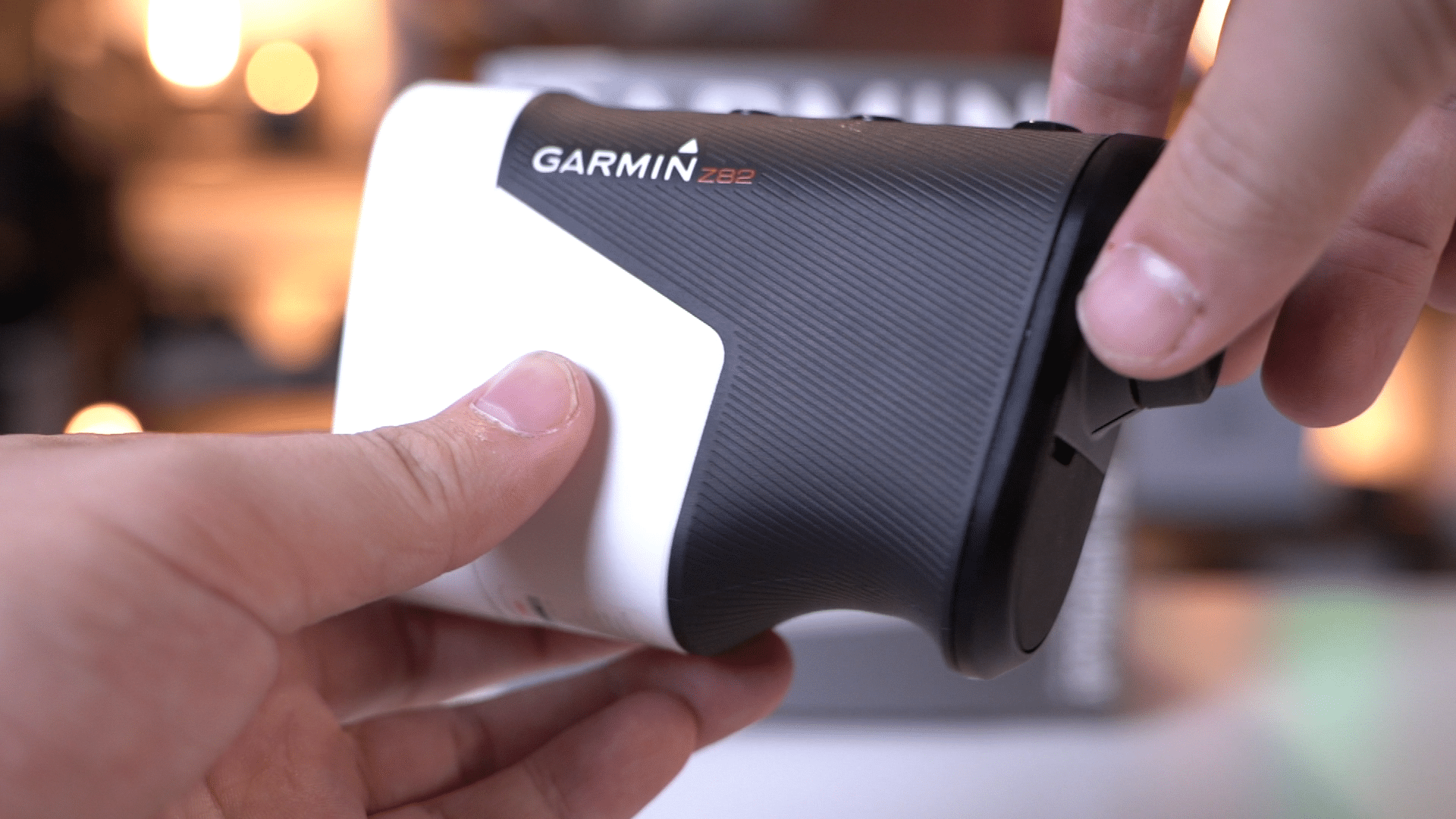 Person holding Garmin Z82 rangefinder device