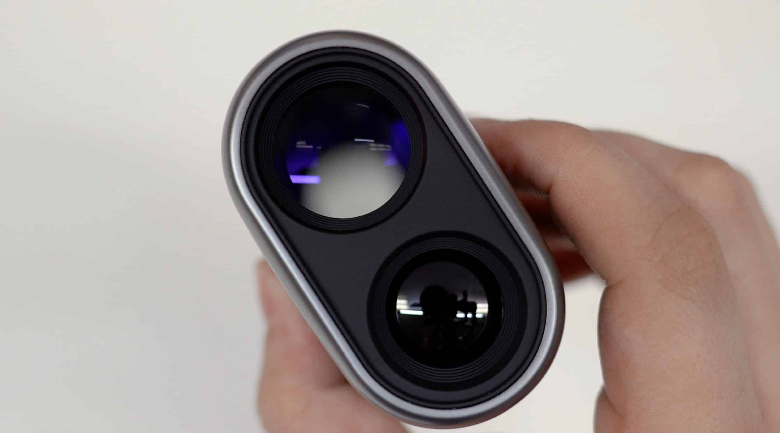 Person holding dual lens camera device