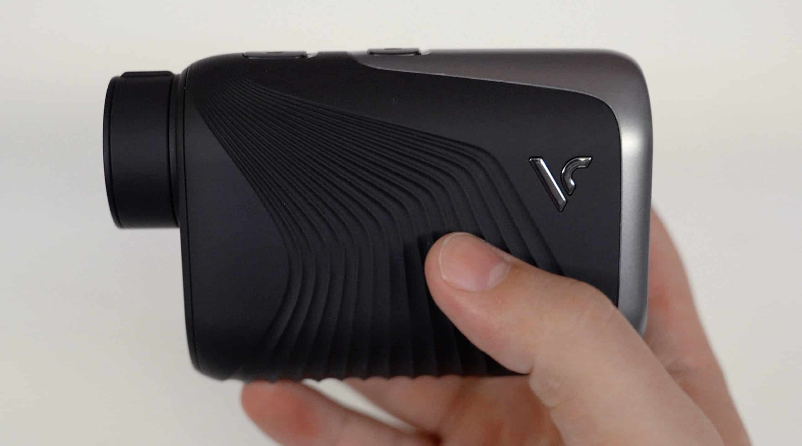 Person holding a compact black camera device