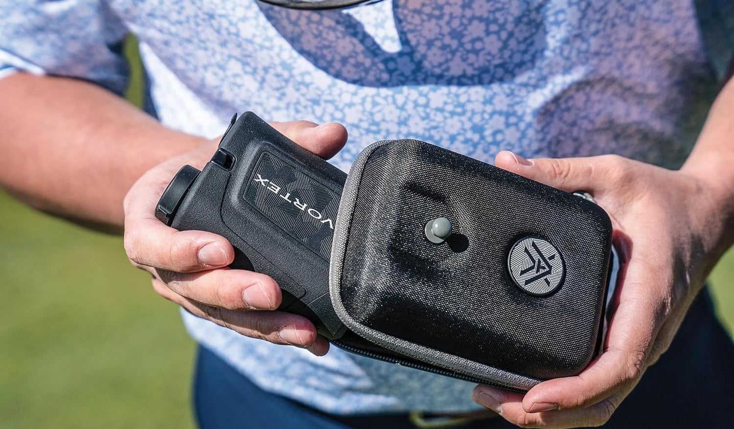 Person holding Vortex rangefinder in carrying case