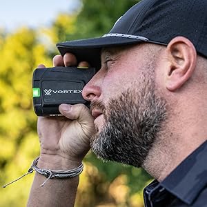 Man using Vortex rangefinder outdoors