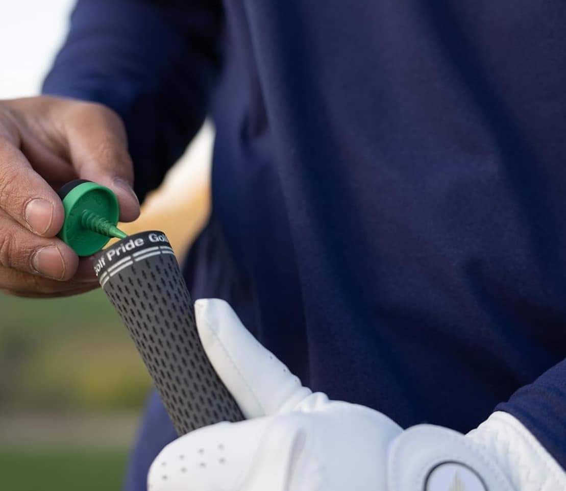 Golfer installing grip with green tool