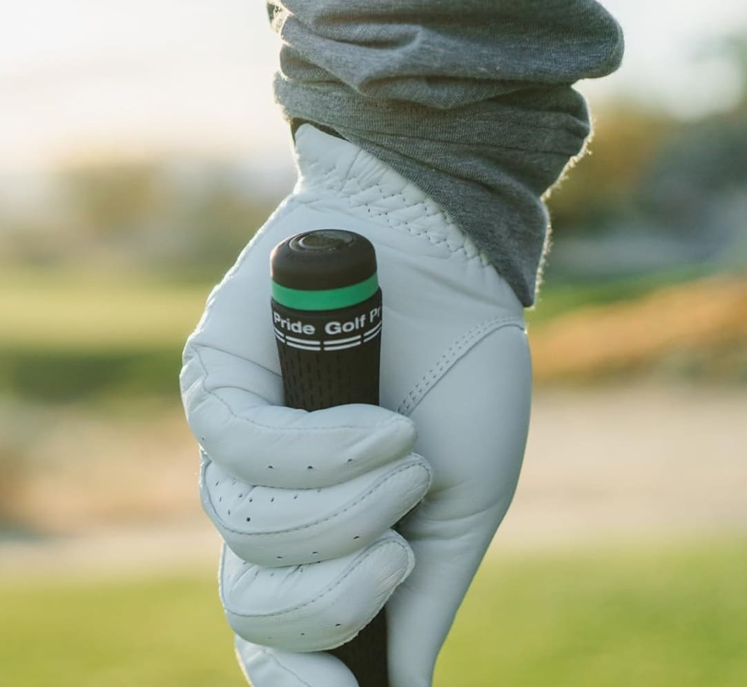 Golfer holding a club with gloved hand