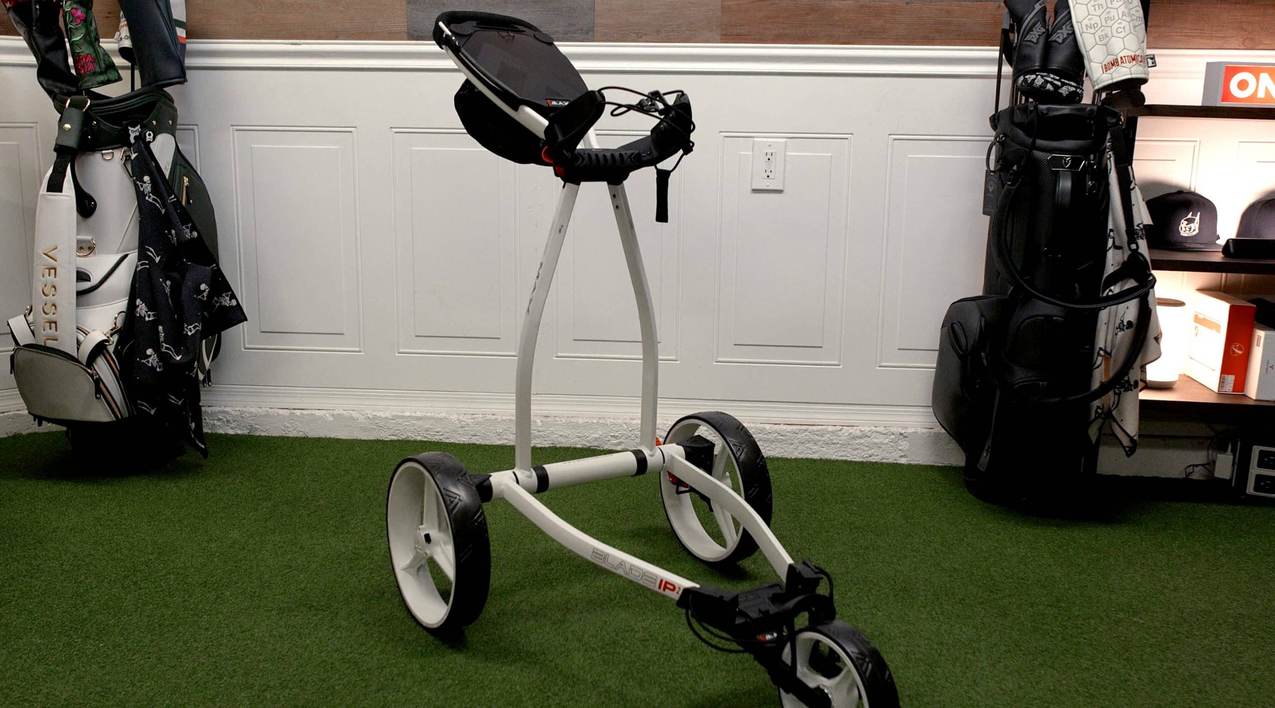 Foldable golf push cart on indoor turf