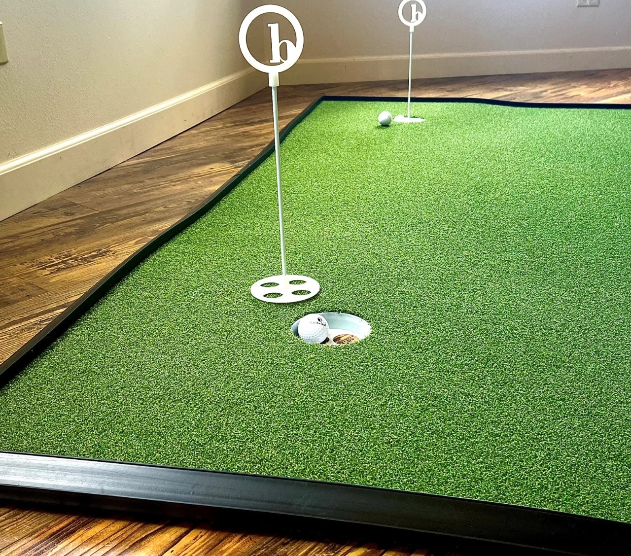 Indoor putting green with golf balls and holes