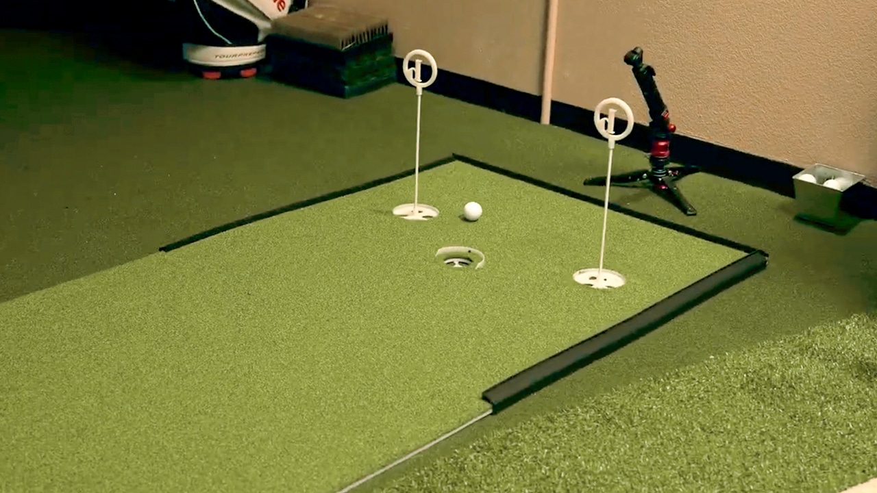 Indoor golf putting green with ball and holes