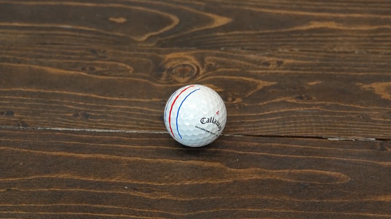 White golf ball on wooden surface
