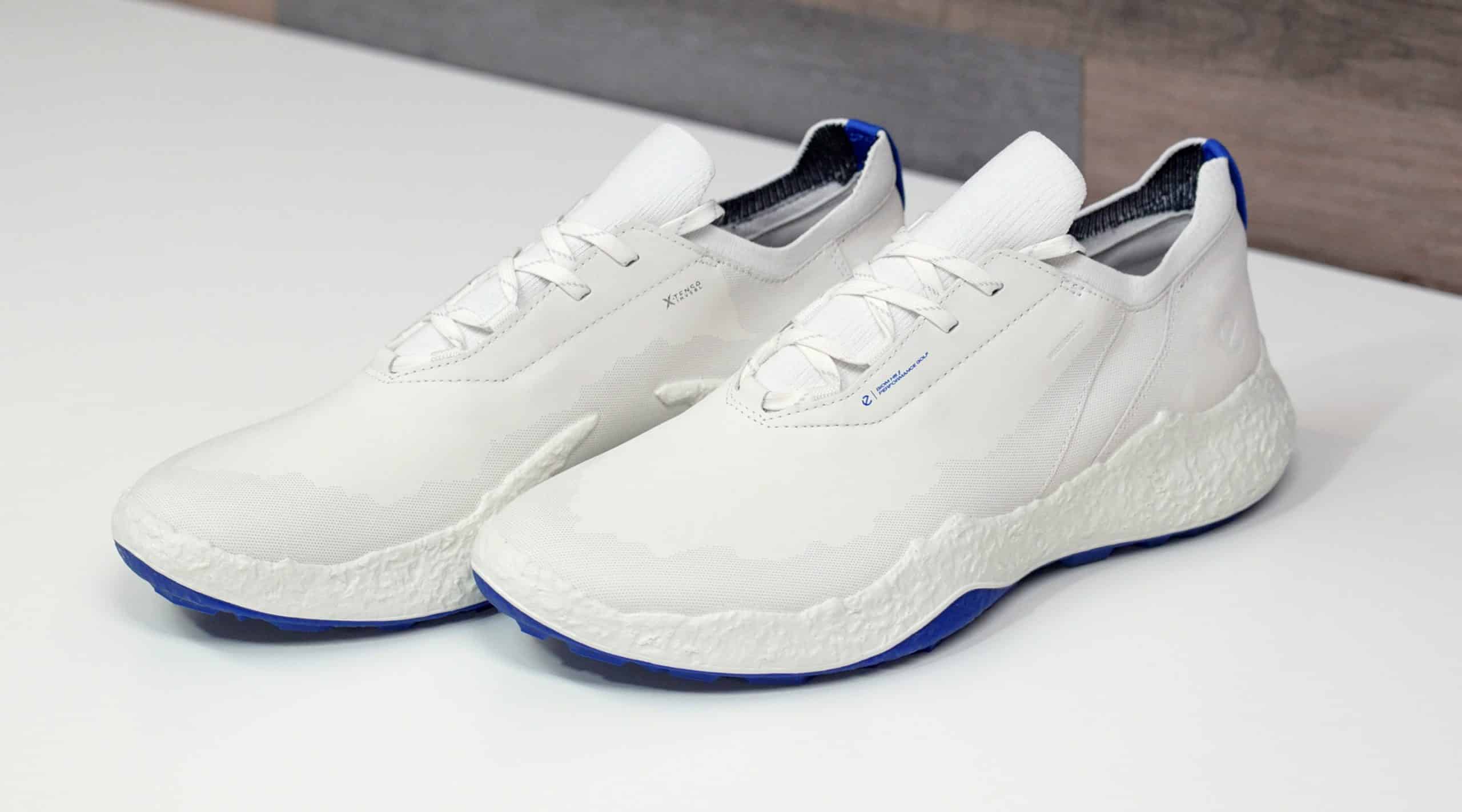 White sneakers with blue soles on table
