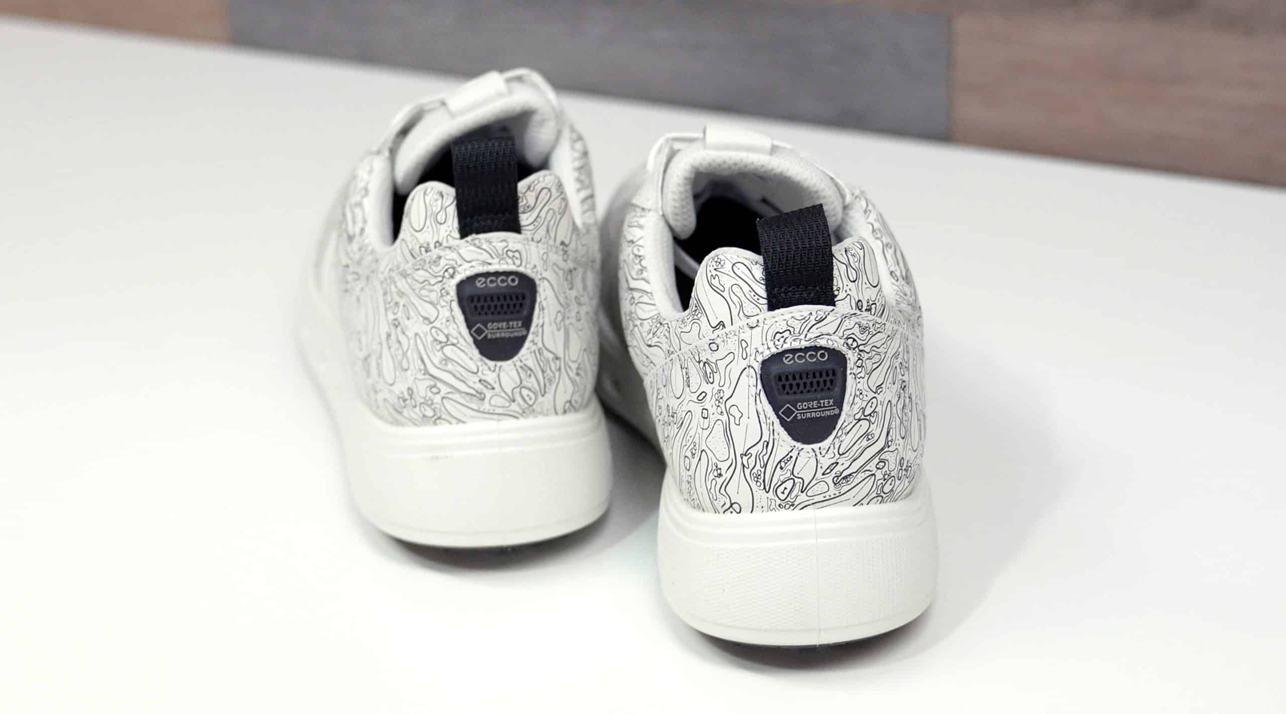 White patterned sneakers with black pull tabs