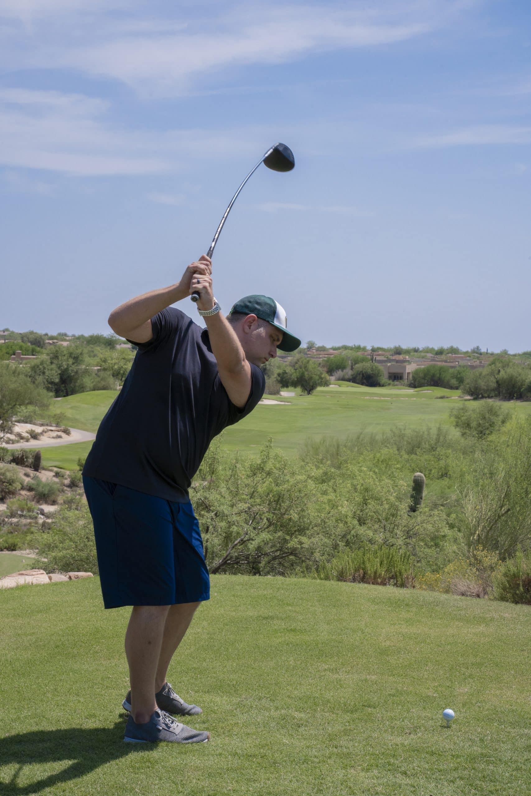 Golfer preparing to swing on sunny golf course