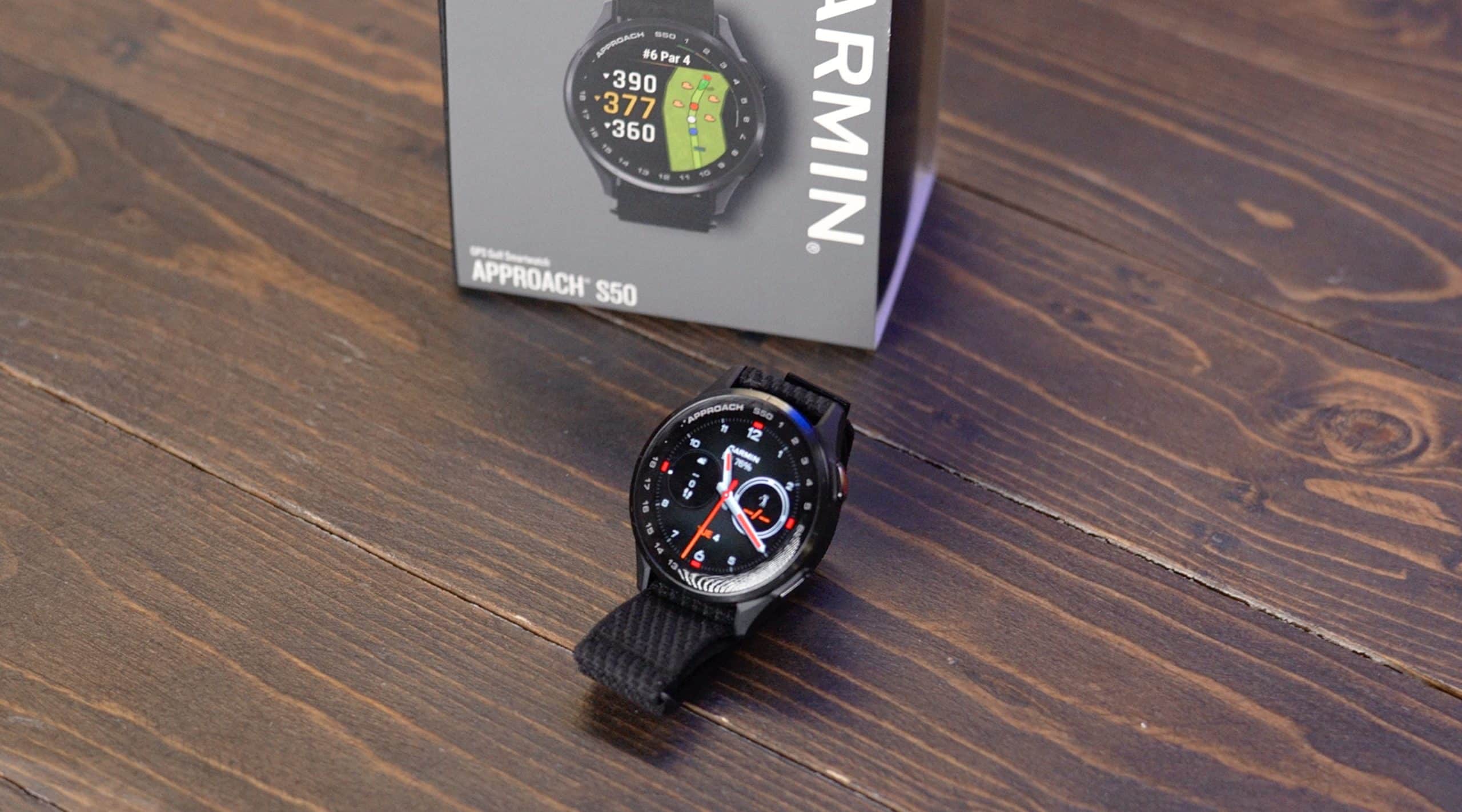 Garmin Approach S50 smartwatch on wooden surface
