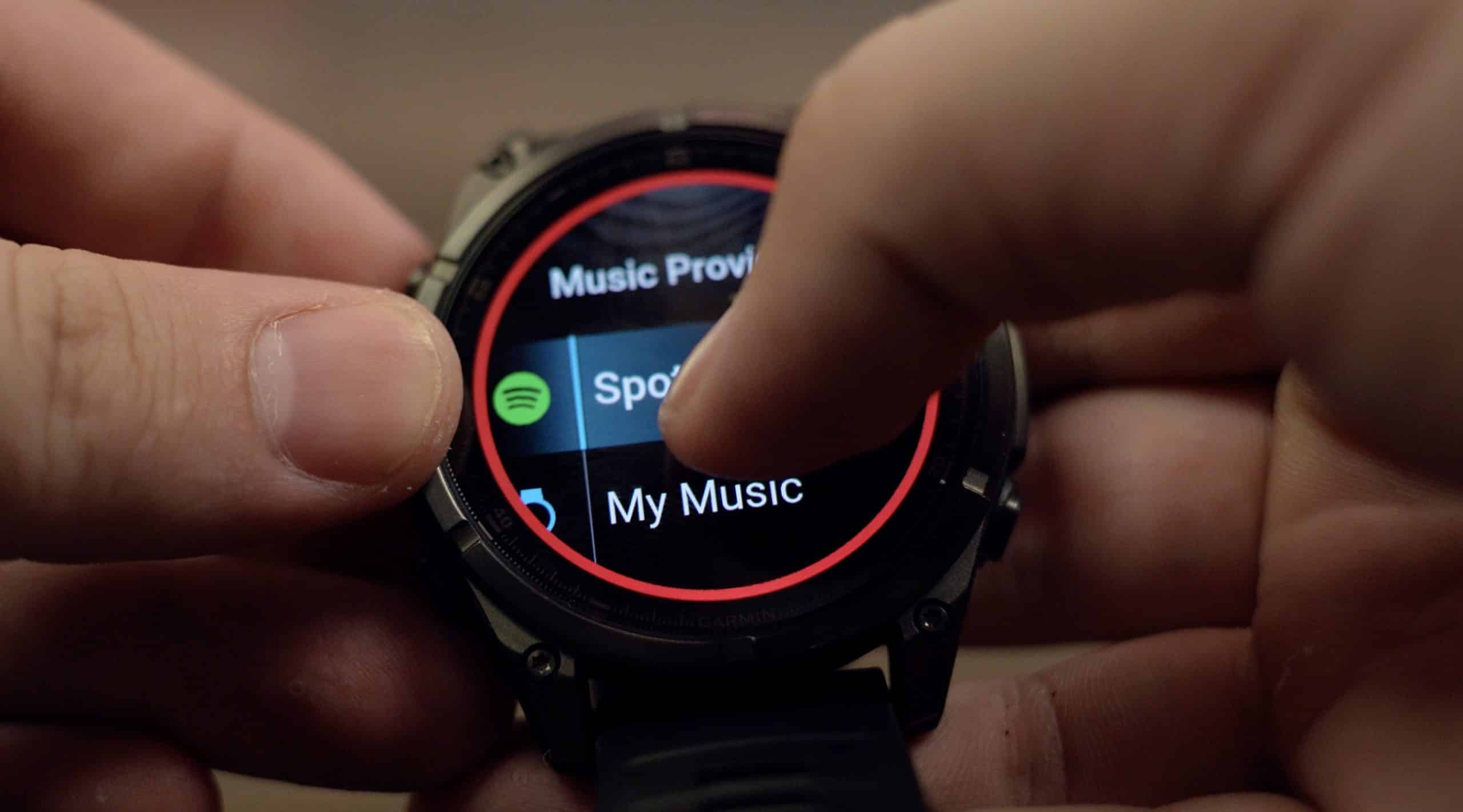 Person using smartwatch to select music app