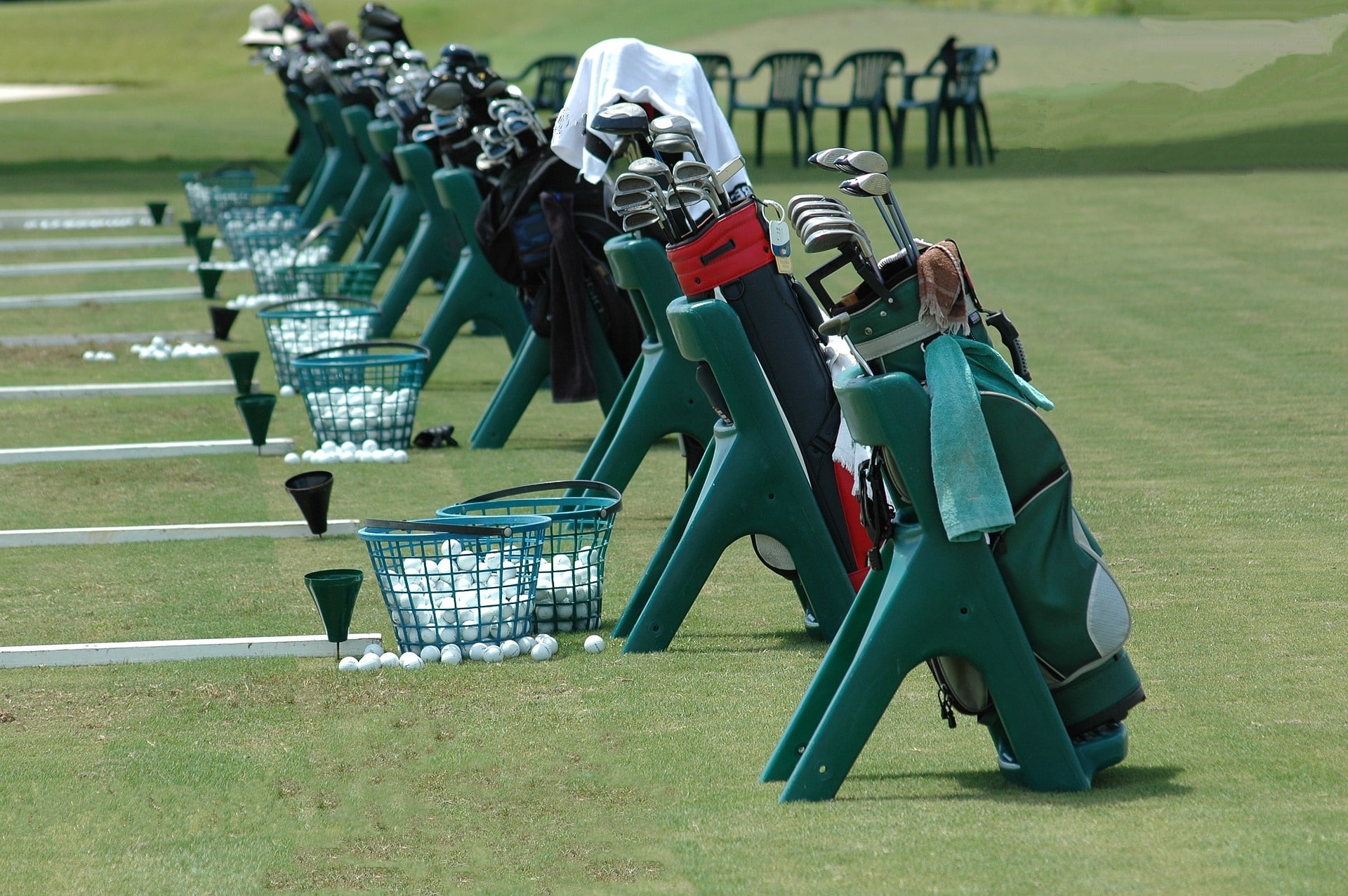 Golf bags and balls on practice range
