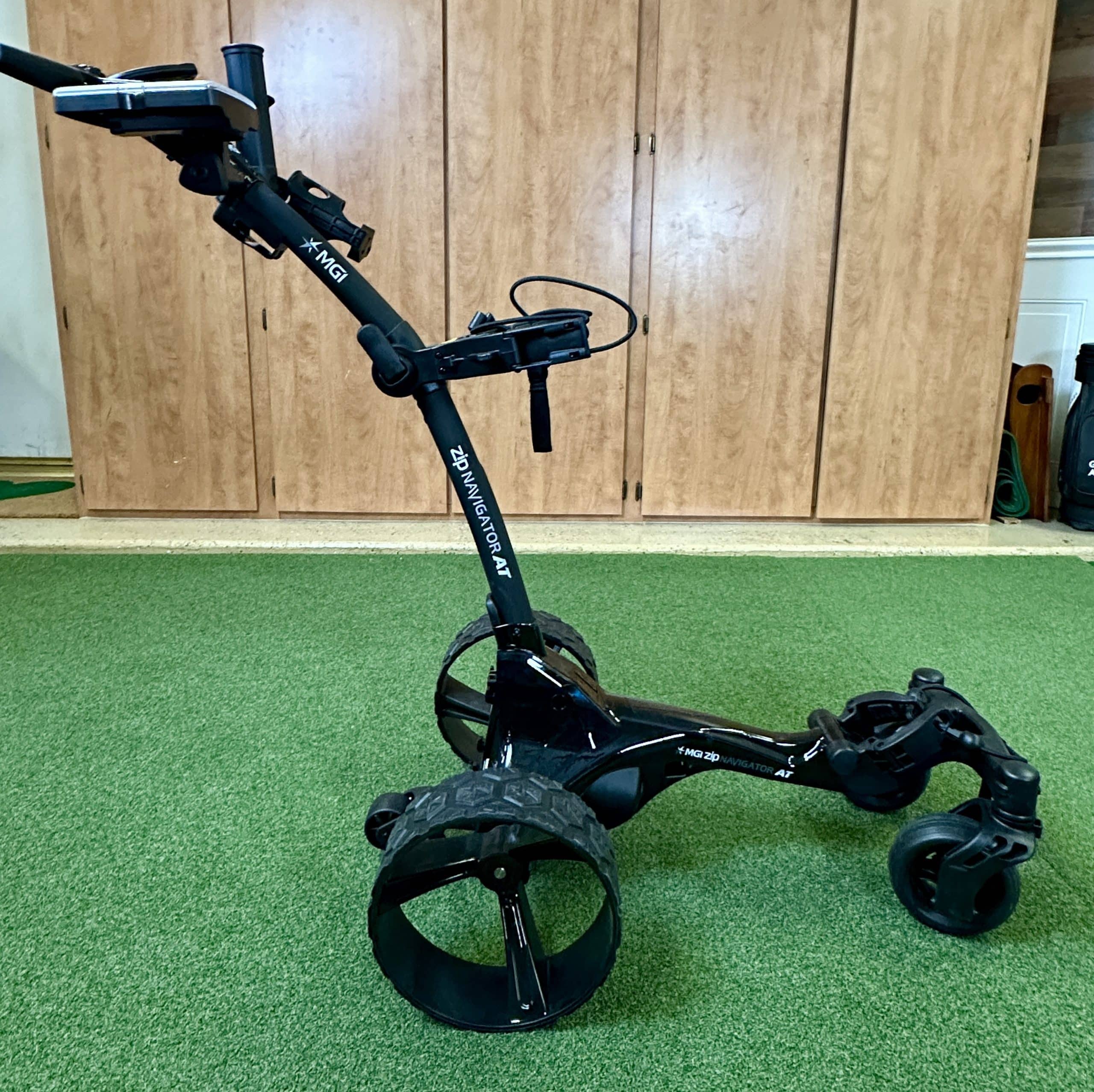 Electric golf push cart on indoor turf