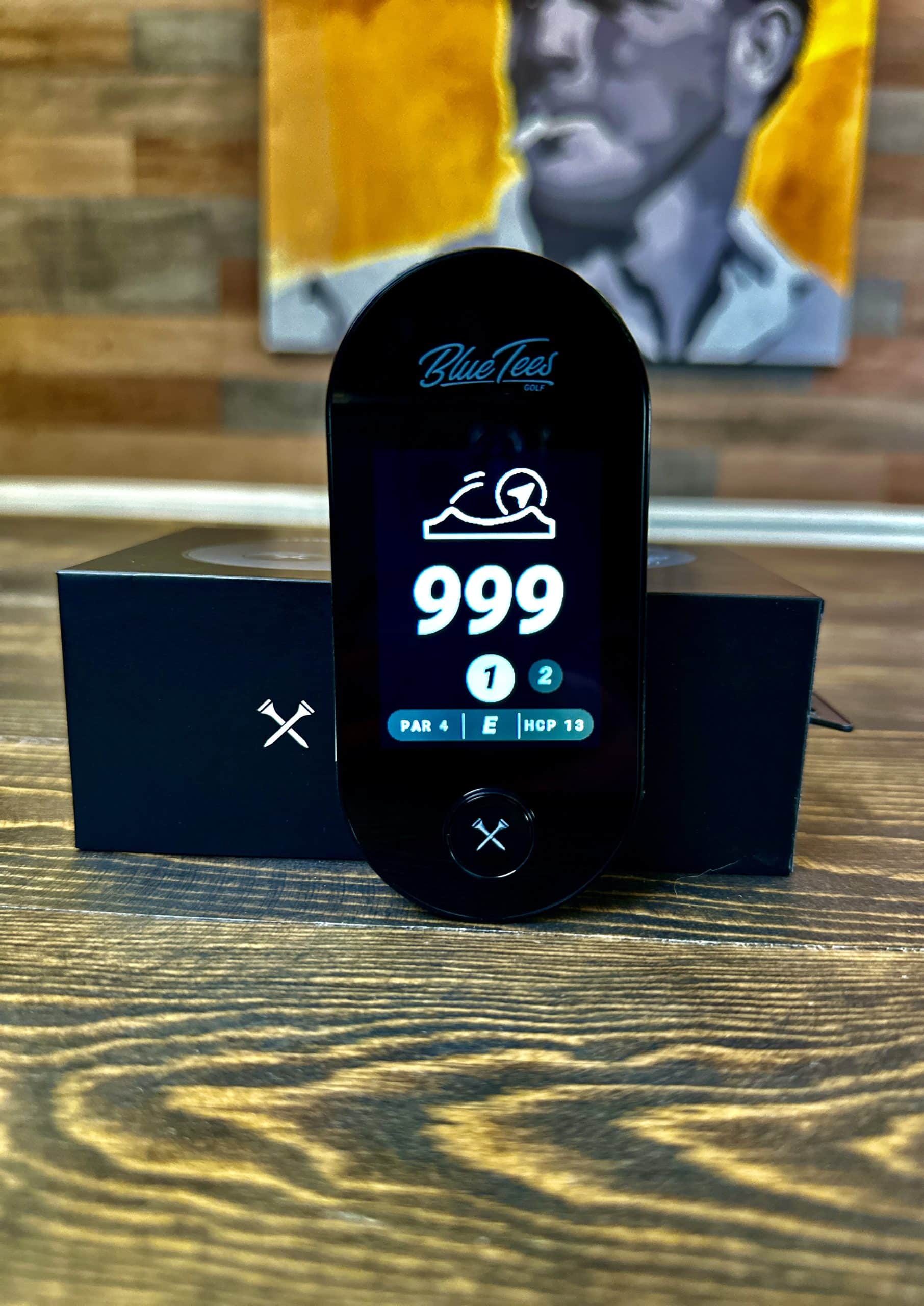 Blue Tees golf rangefinder on wooden table