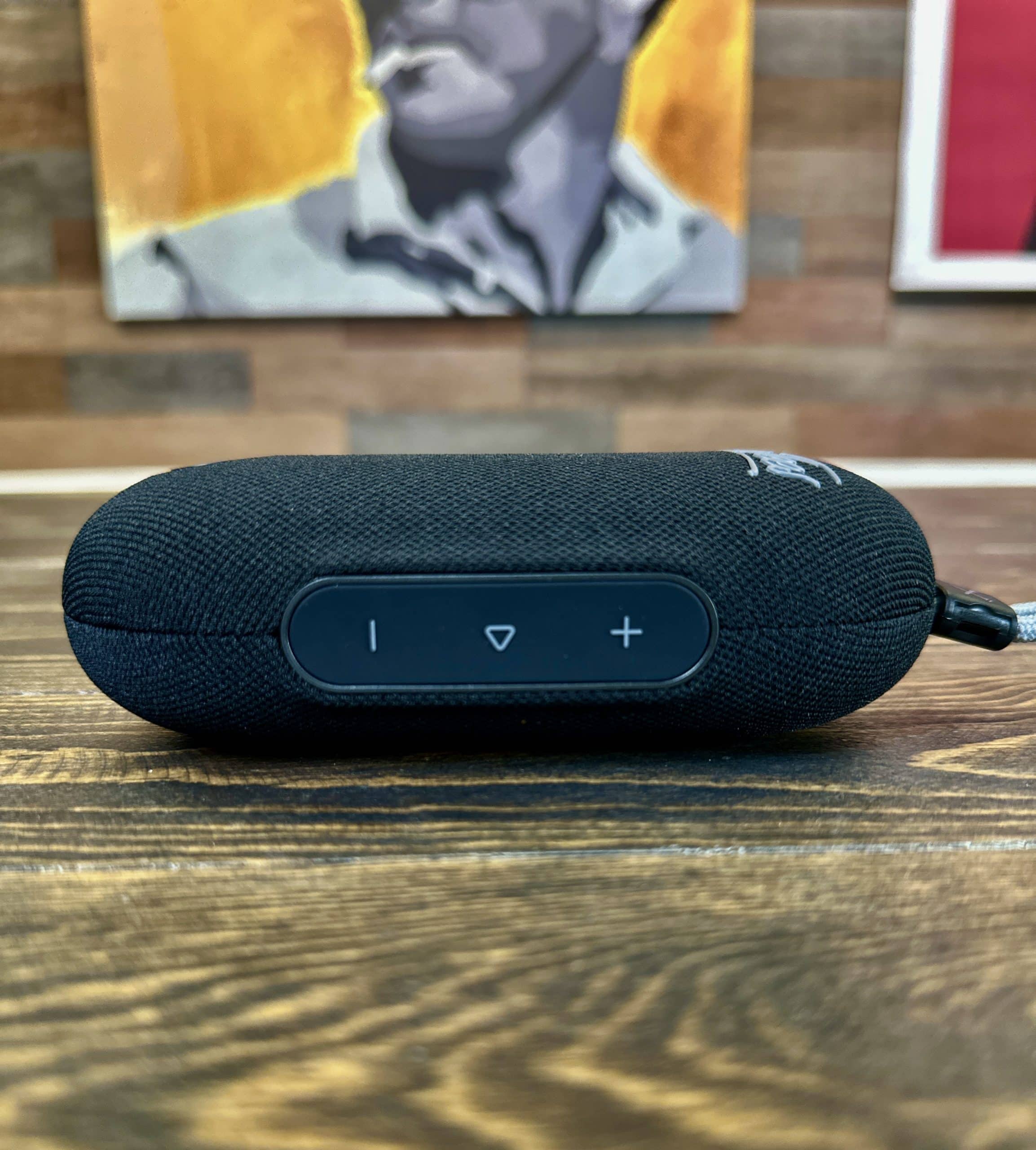 Black portable Bluetooth speaker on wooden table