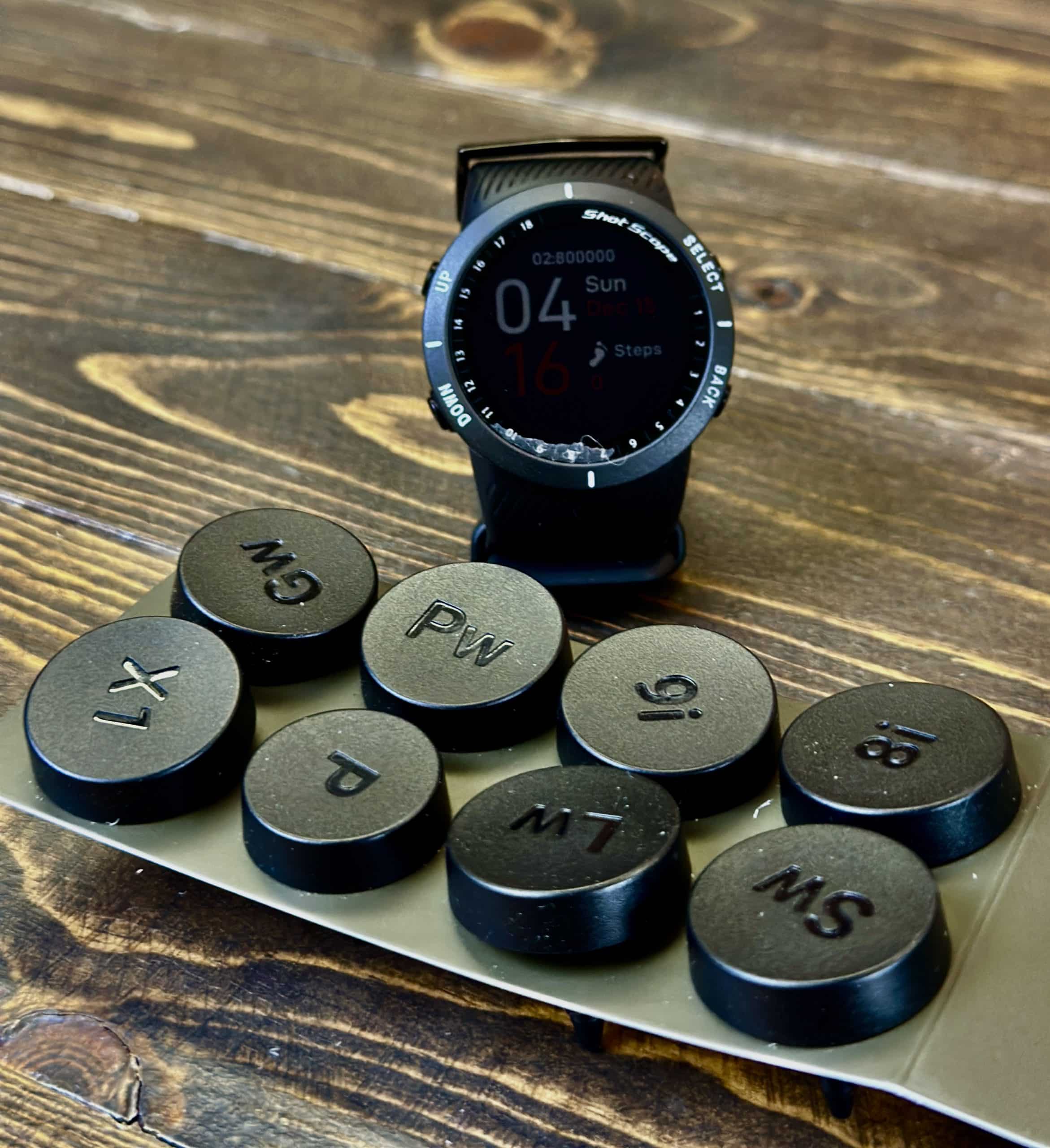 Smartwatch beside golf club selection buttons