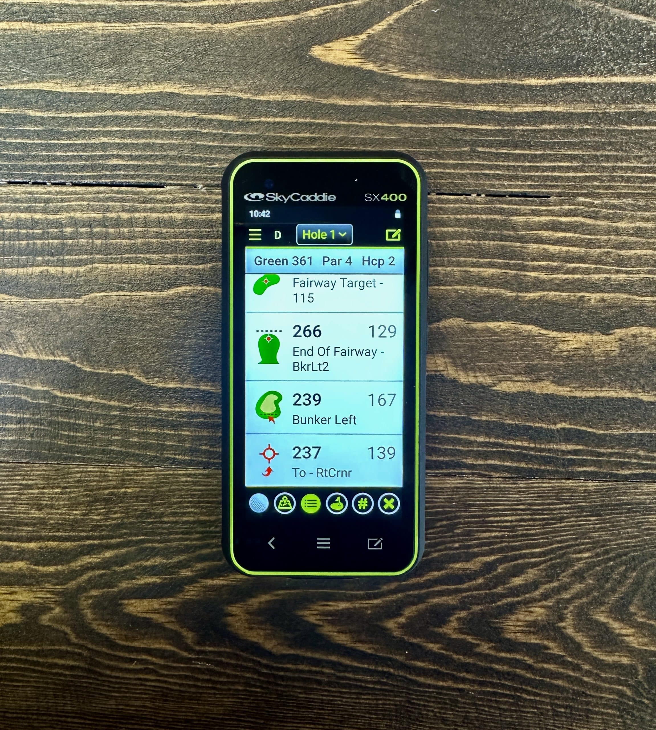 SkyCaddie SX400 golf GPS on wooden table
