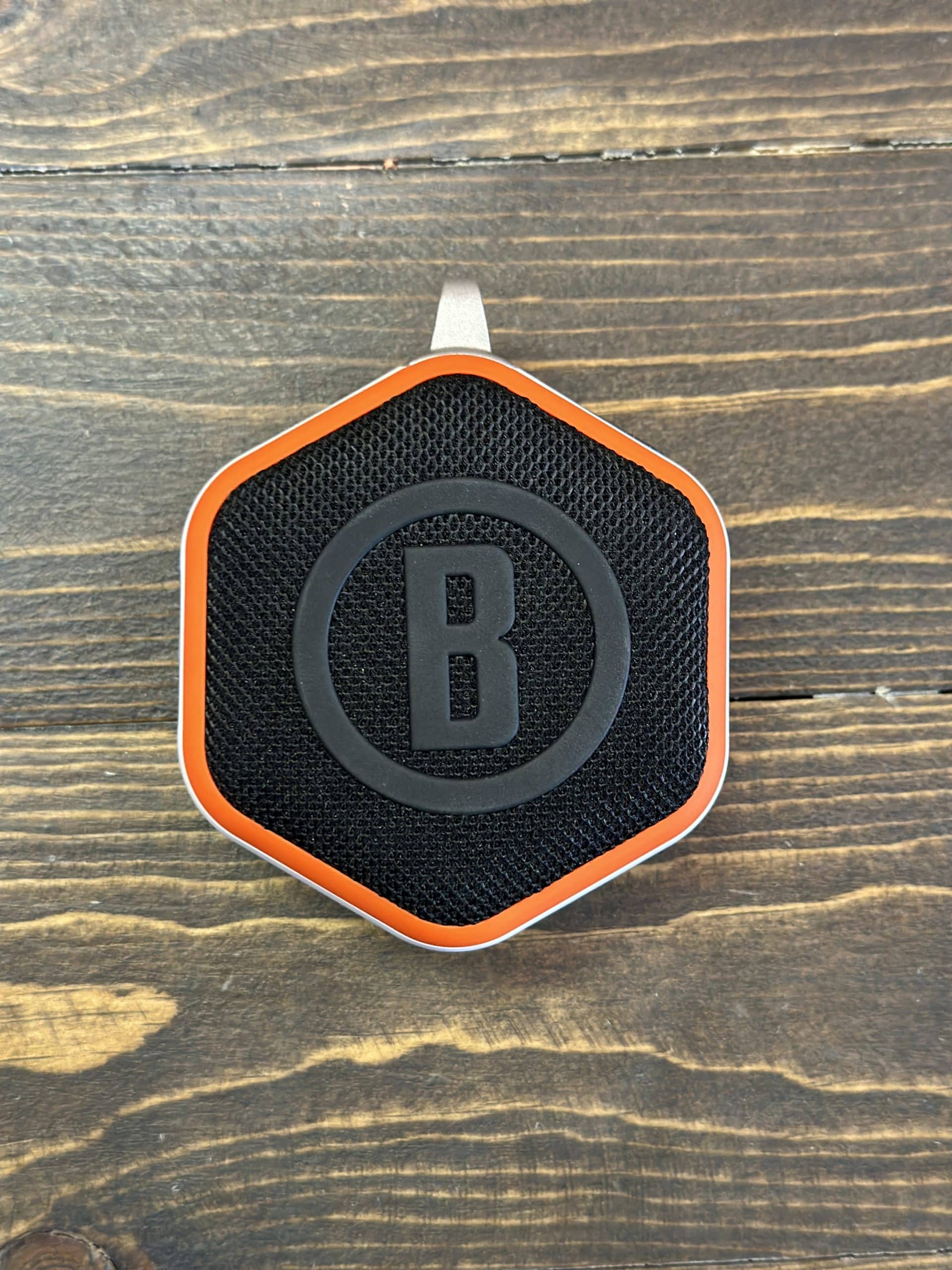 Hexagonal portable Bluetooth speaker on wooden surface