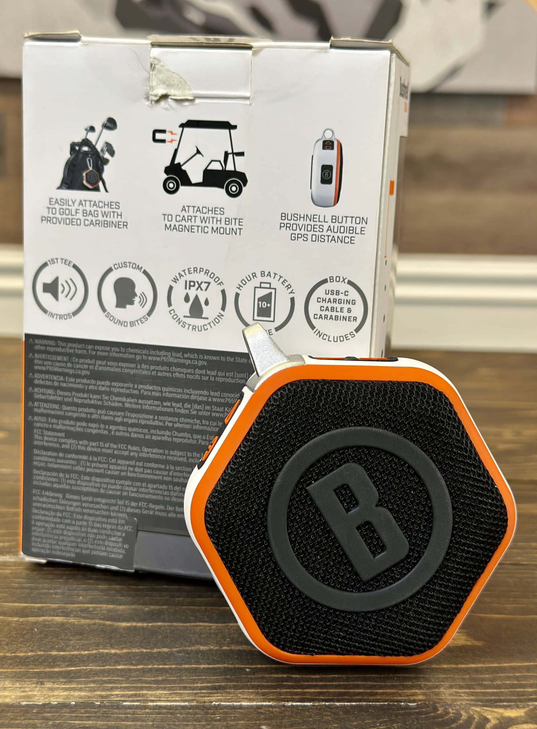 Bushnell golf speaker with packaging on table
