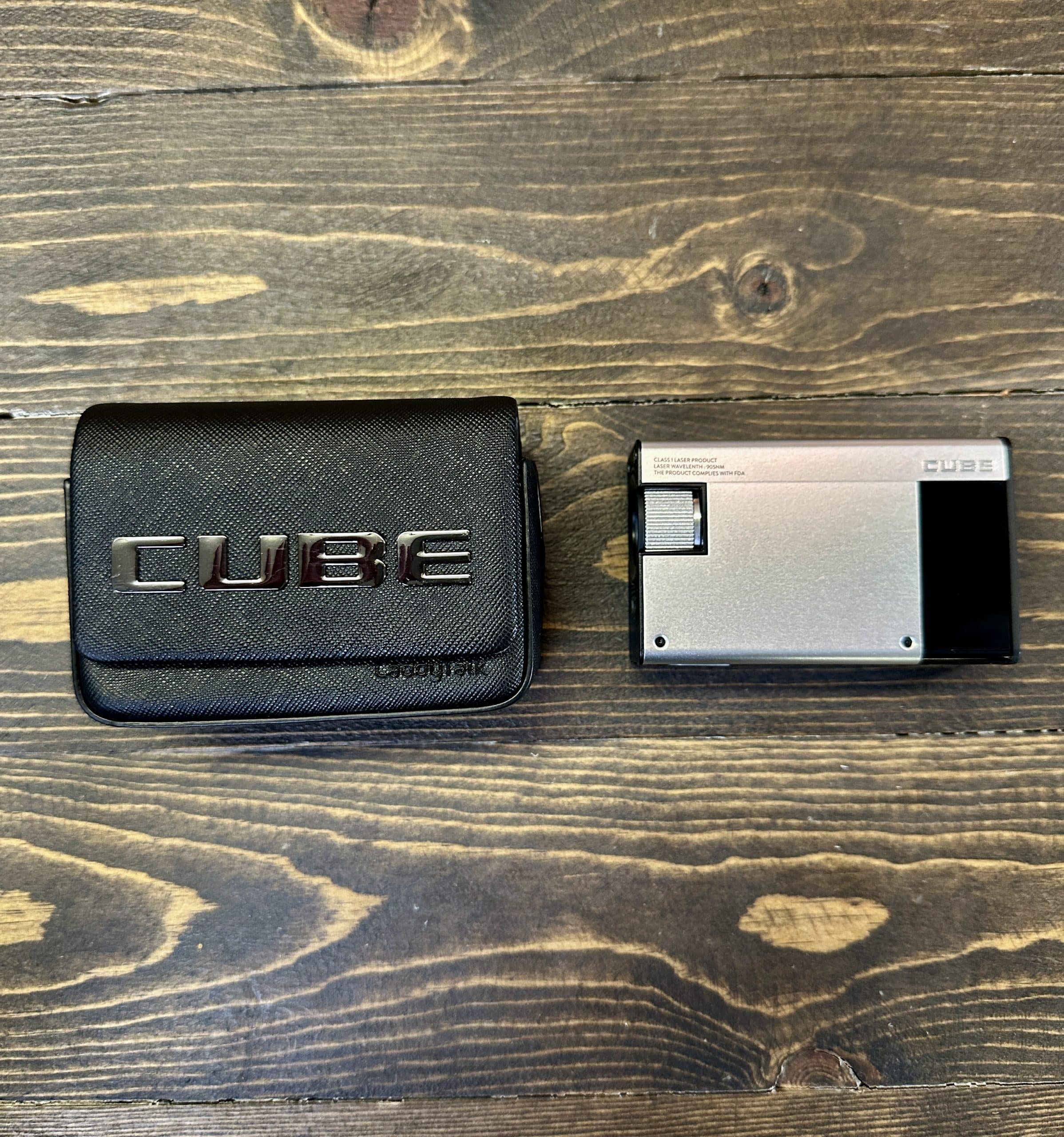 CUBE portable projector and carrying case on table