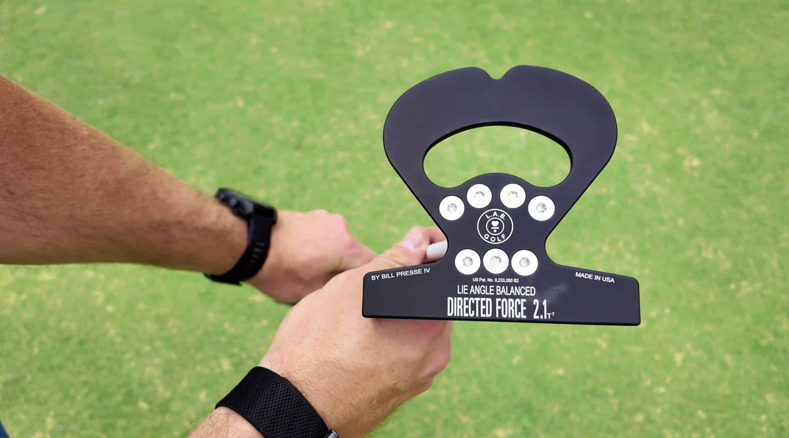 Golfer holding a L.A.B. Golf putter