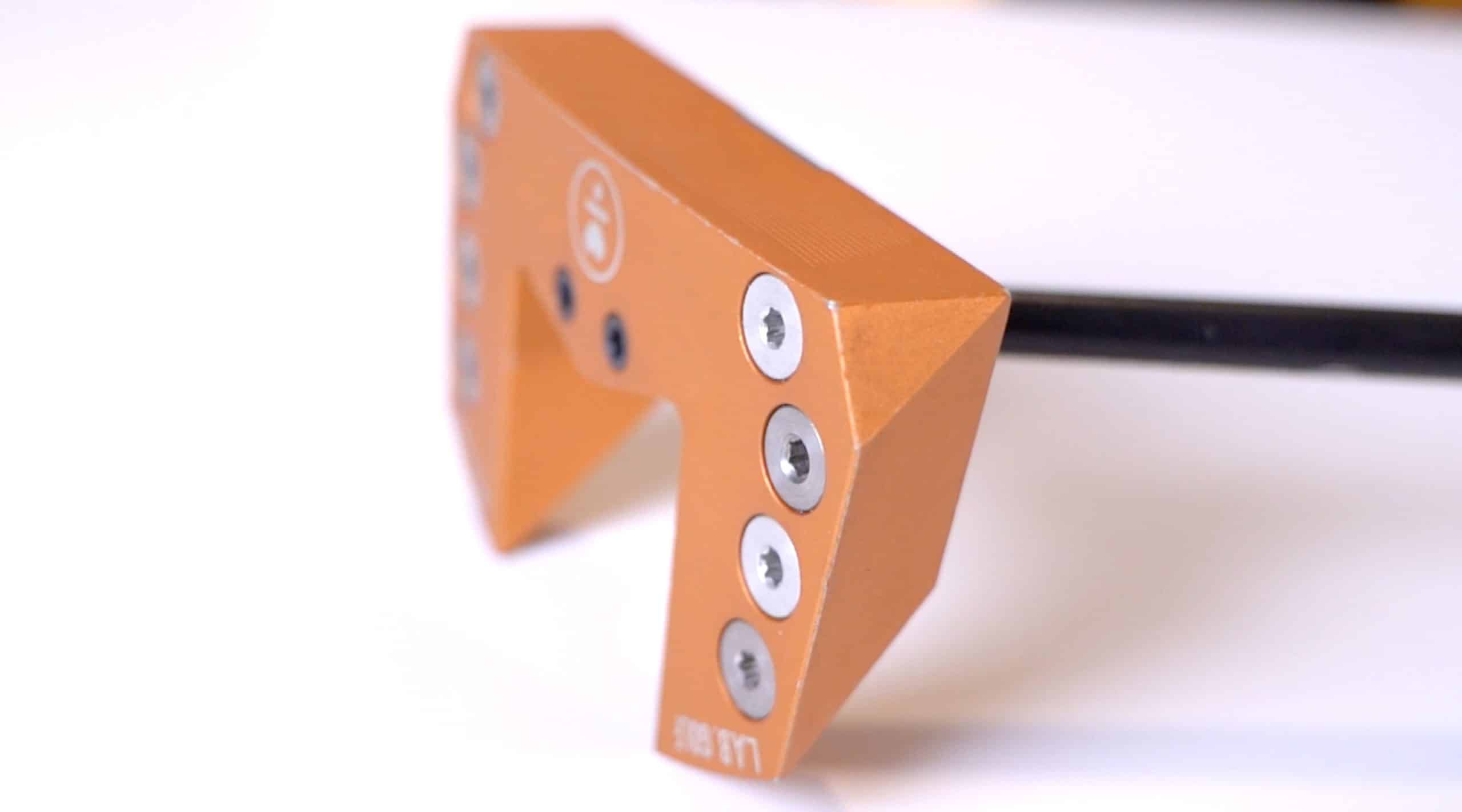 Orange metal tool head with hex screws