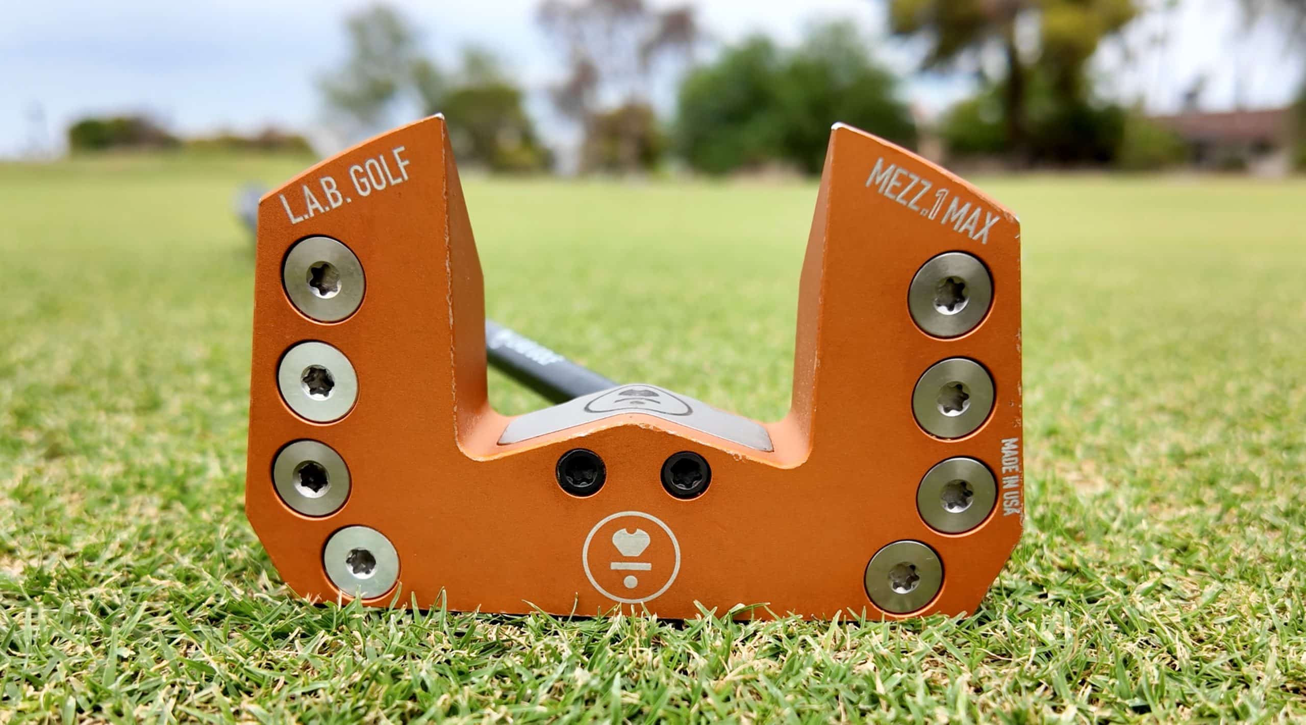 Orange L.A.B. Golf putter on green grass