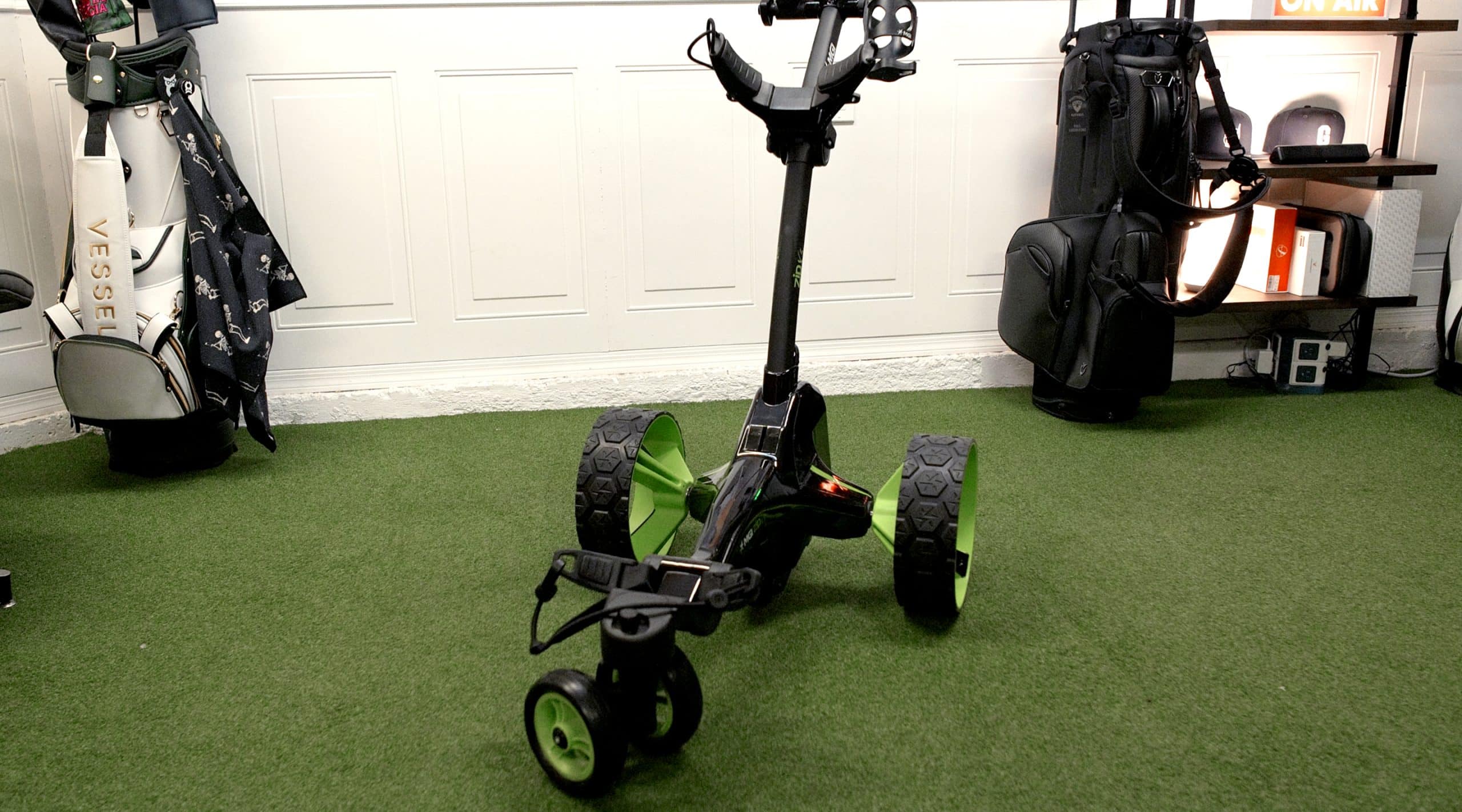 Electric golf push cart on indoor turf