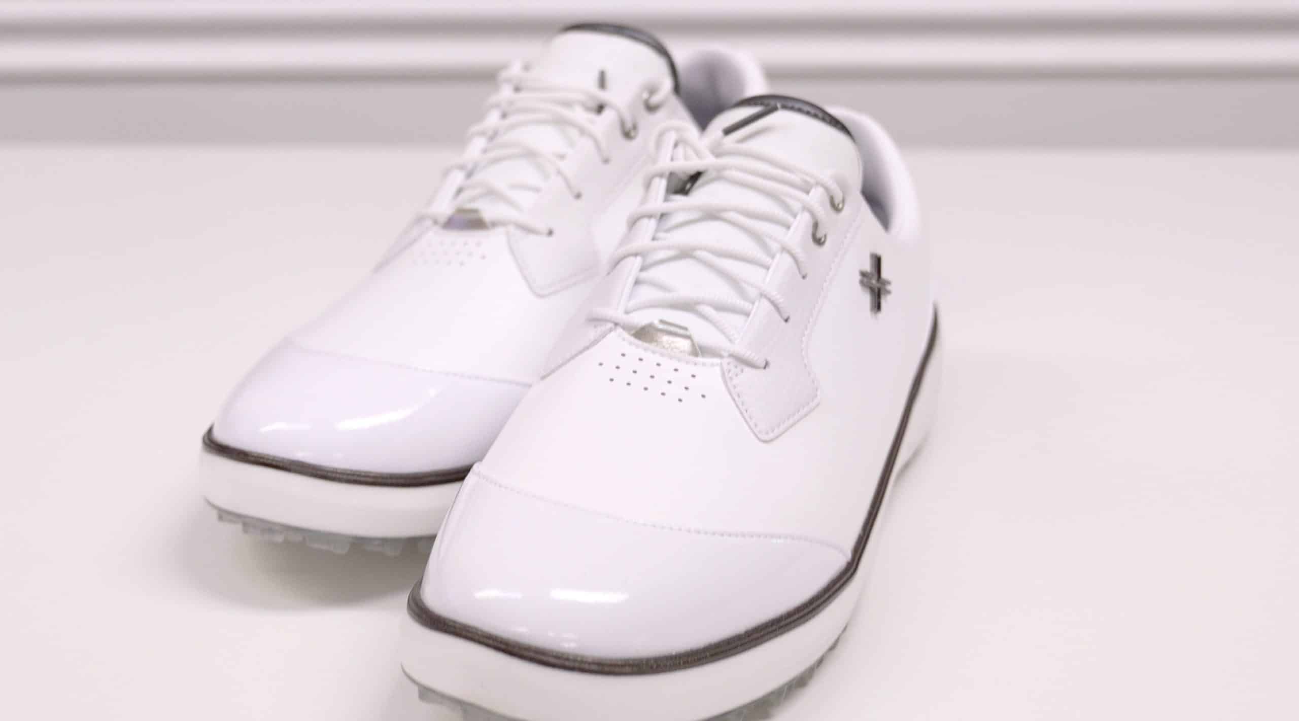 White leather golf shoes on display