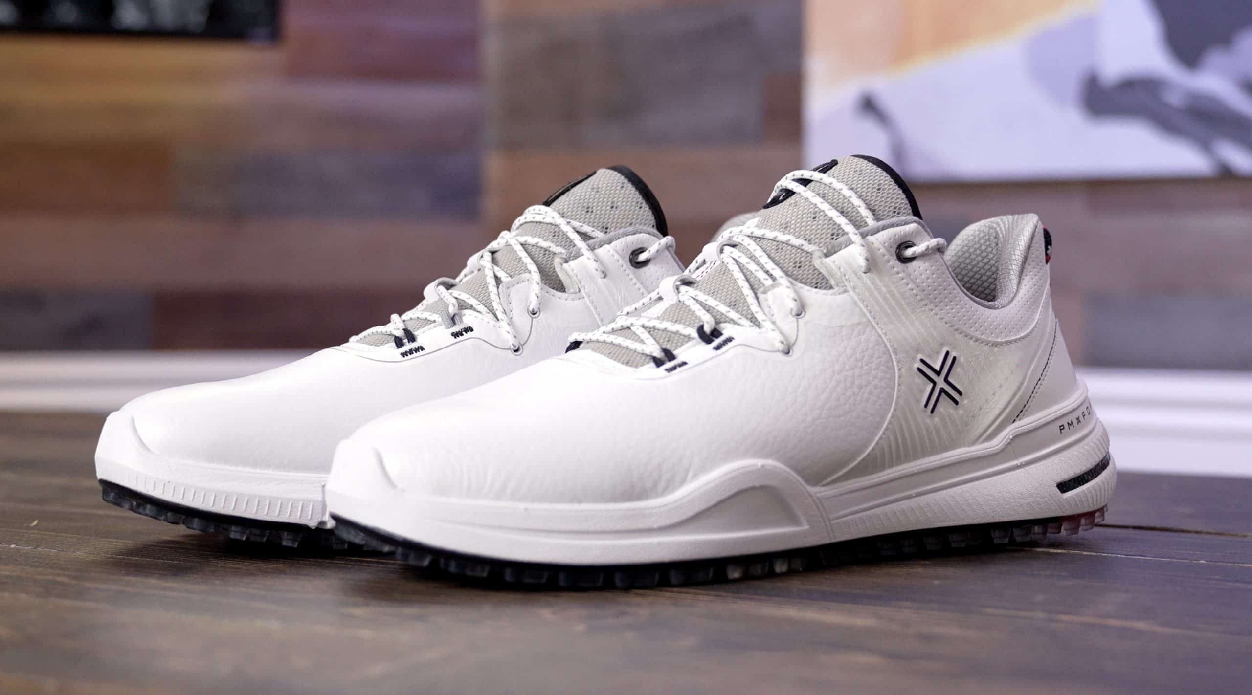 White athletic shoes on wooden surface