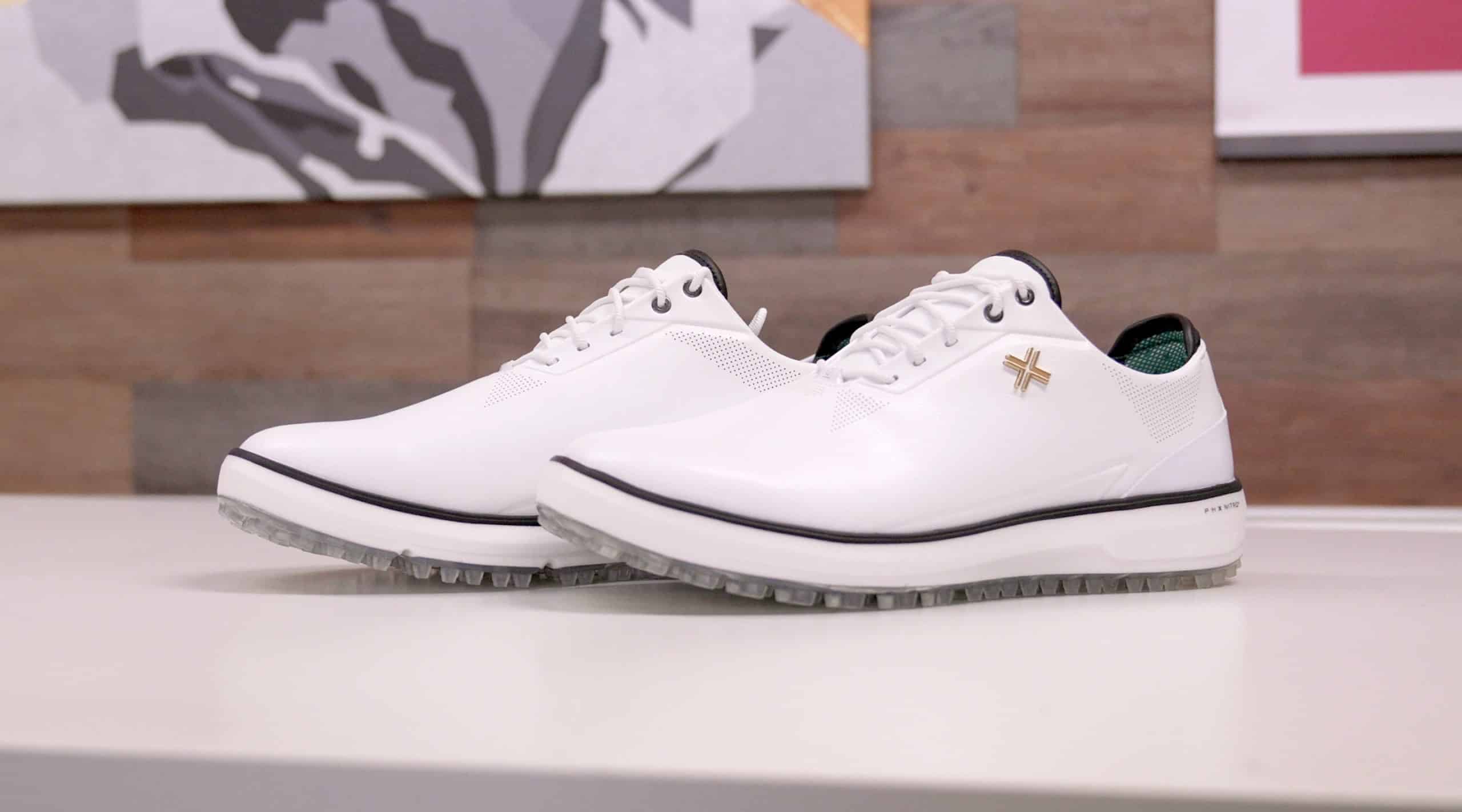 White leather golf shoes on a table