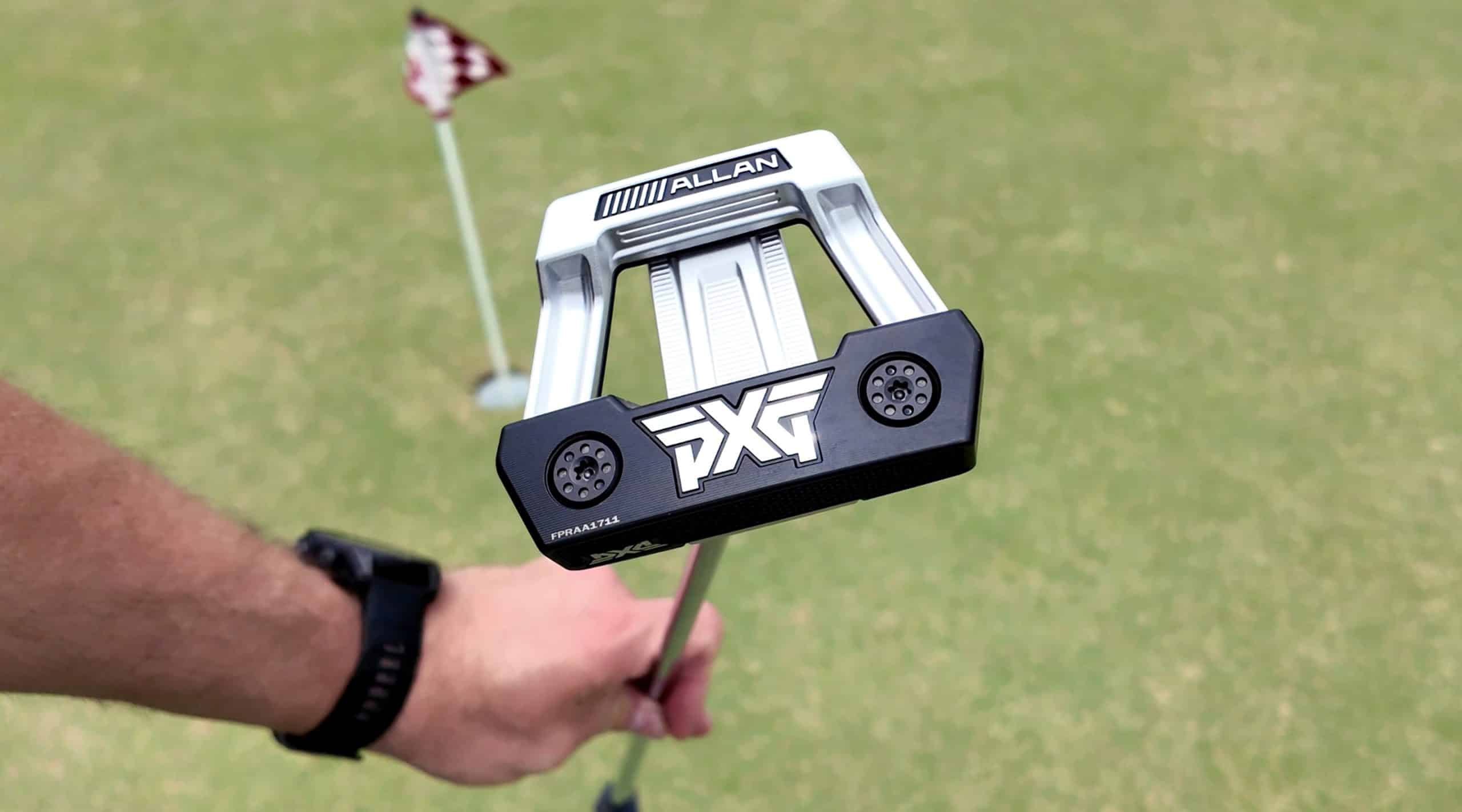 Golfer holding PXG putter on green