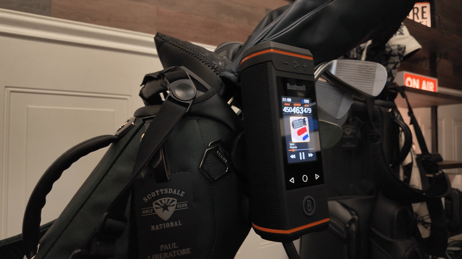 Bushnell speaker attached to golf bag indoors