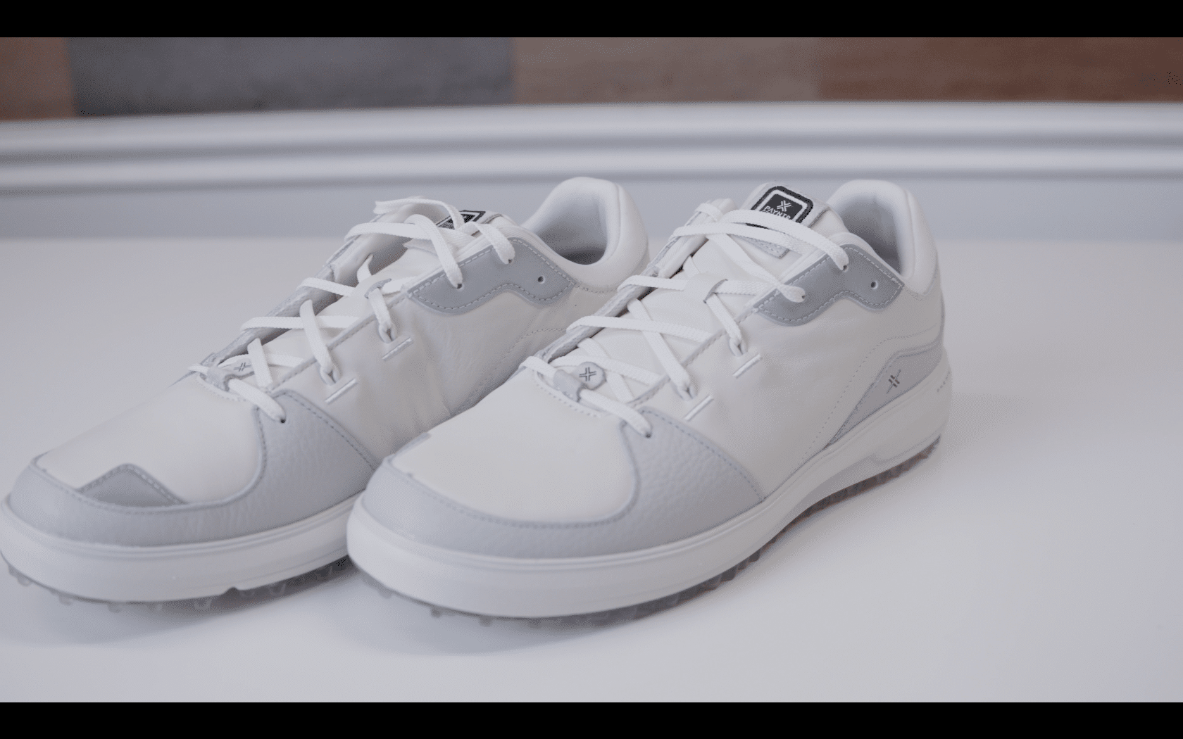 White and gray athletic sneakers on table