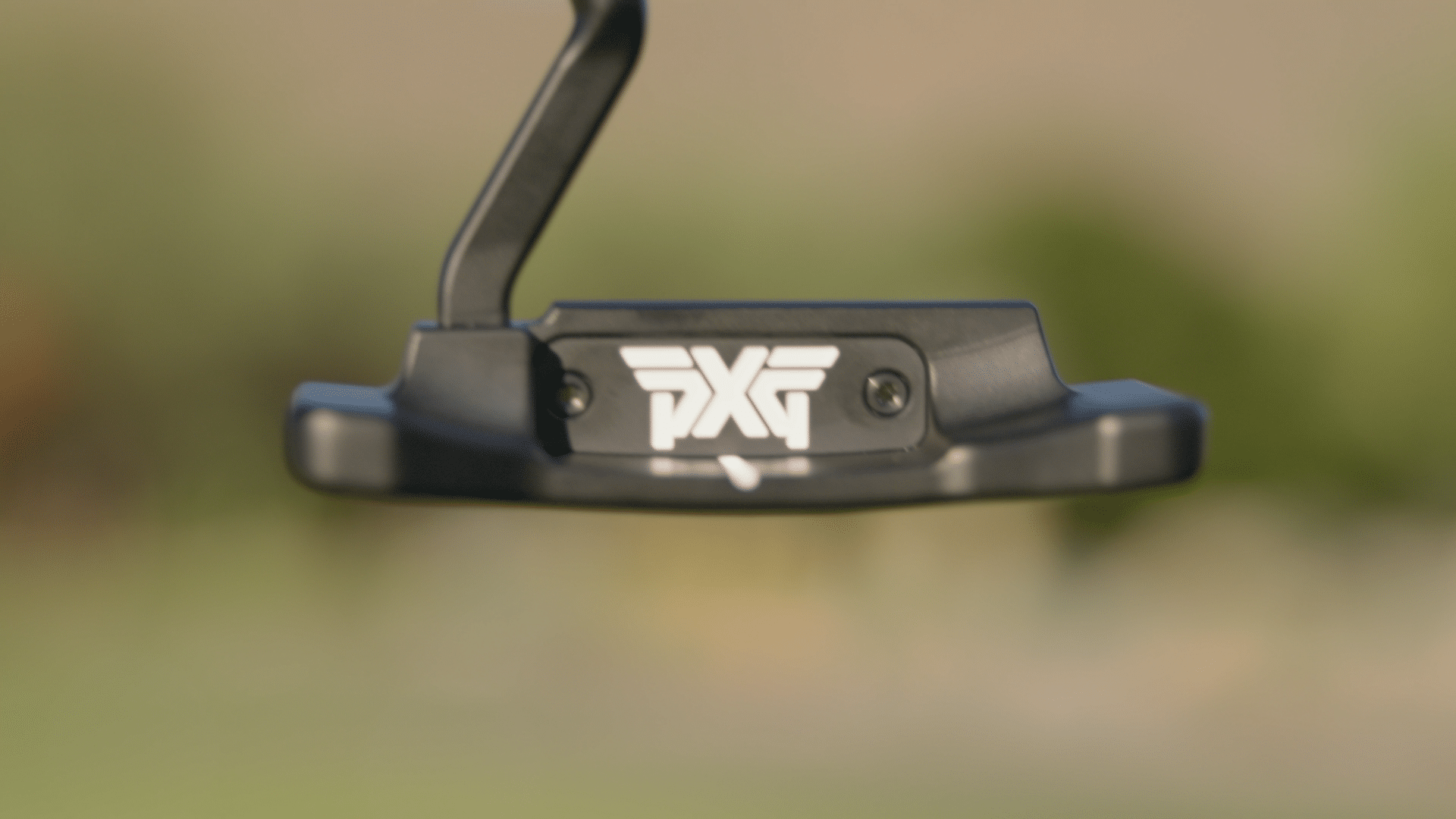 Black PXG golf putter close-up outdoors
