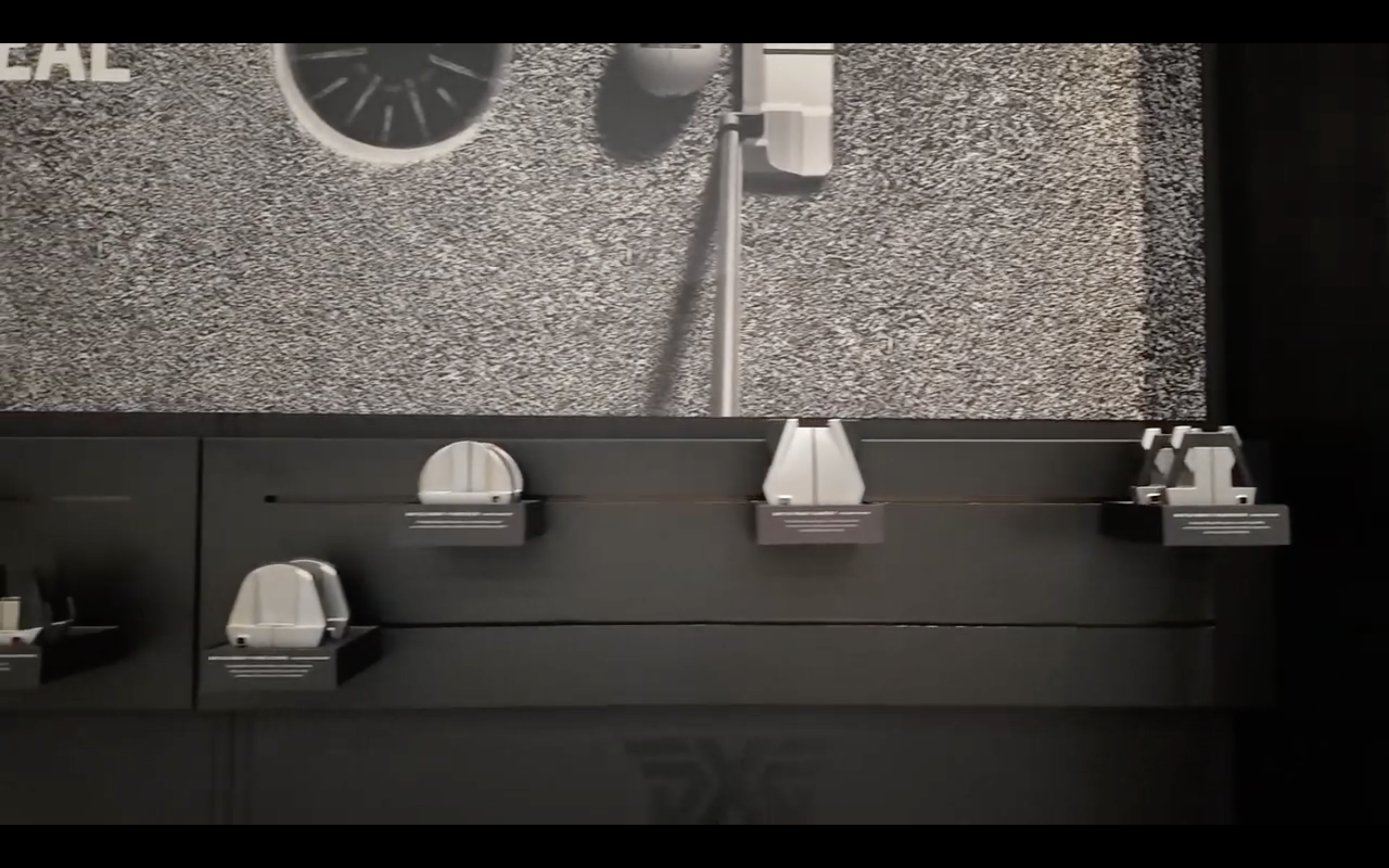 Modern golf putters displayed on a wall rack