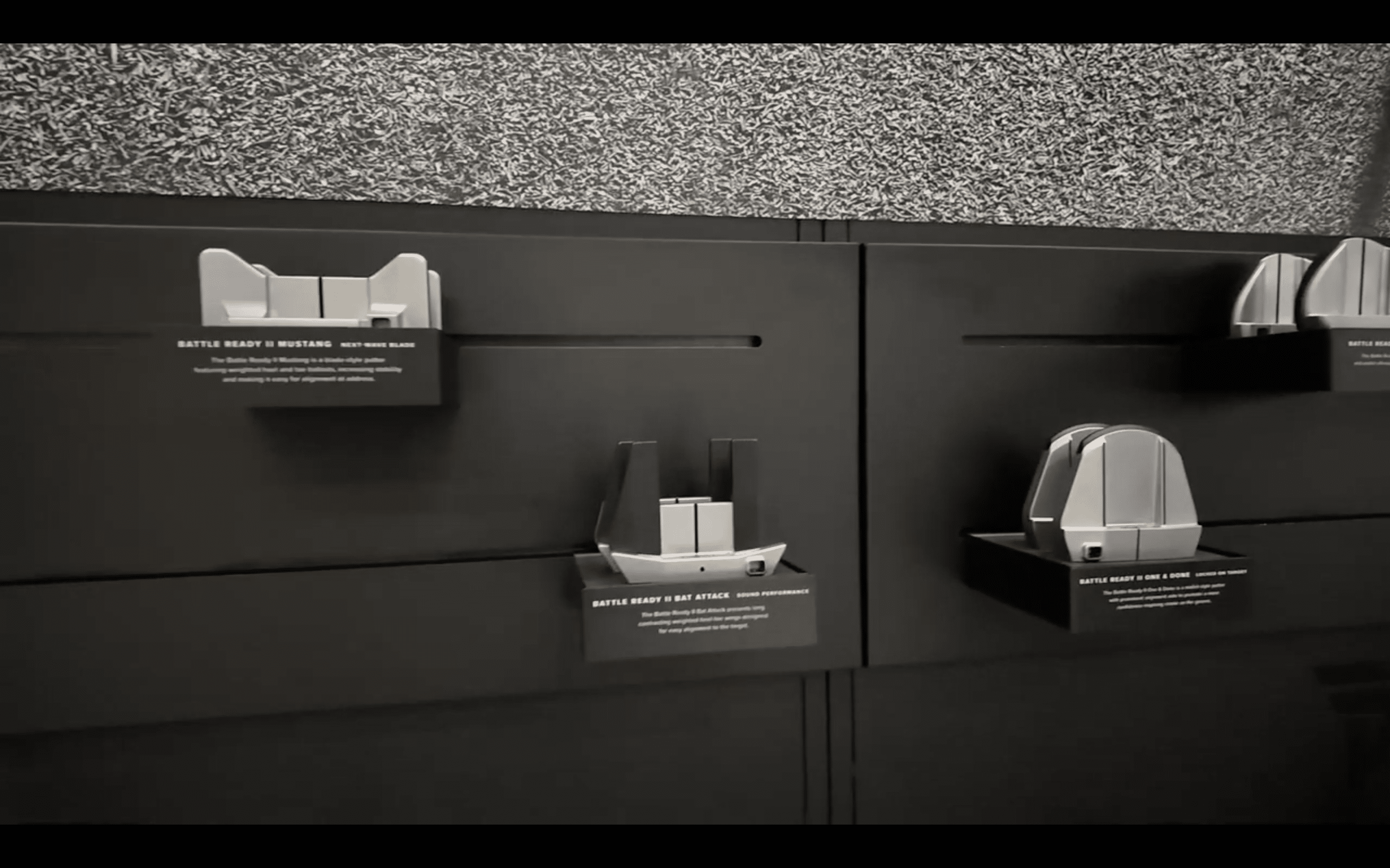 Display of futuristic metallic gadgets on black wall