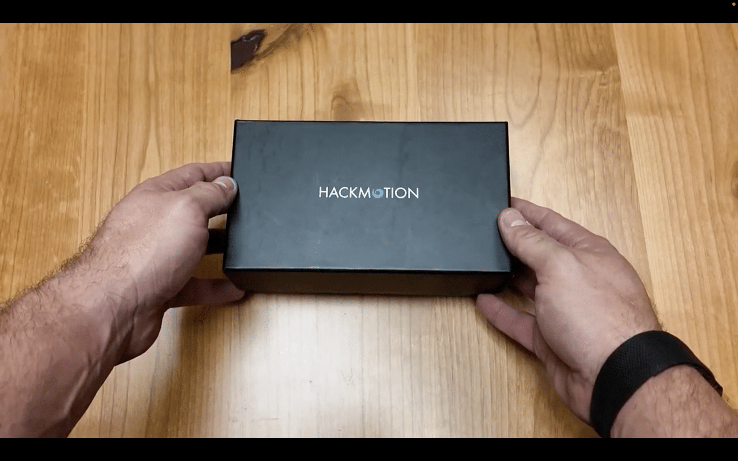 Hands holding a HackMotion product box