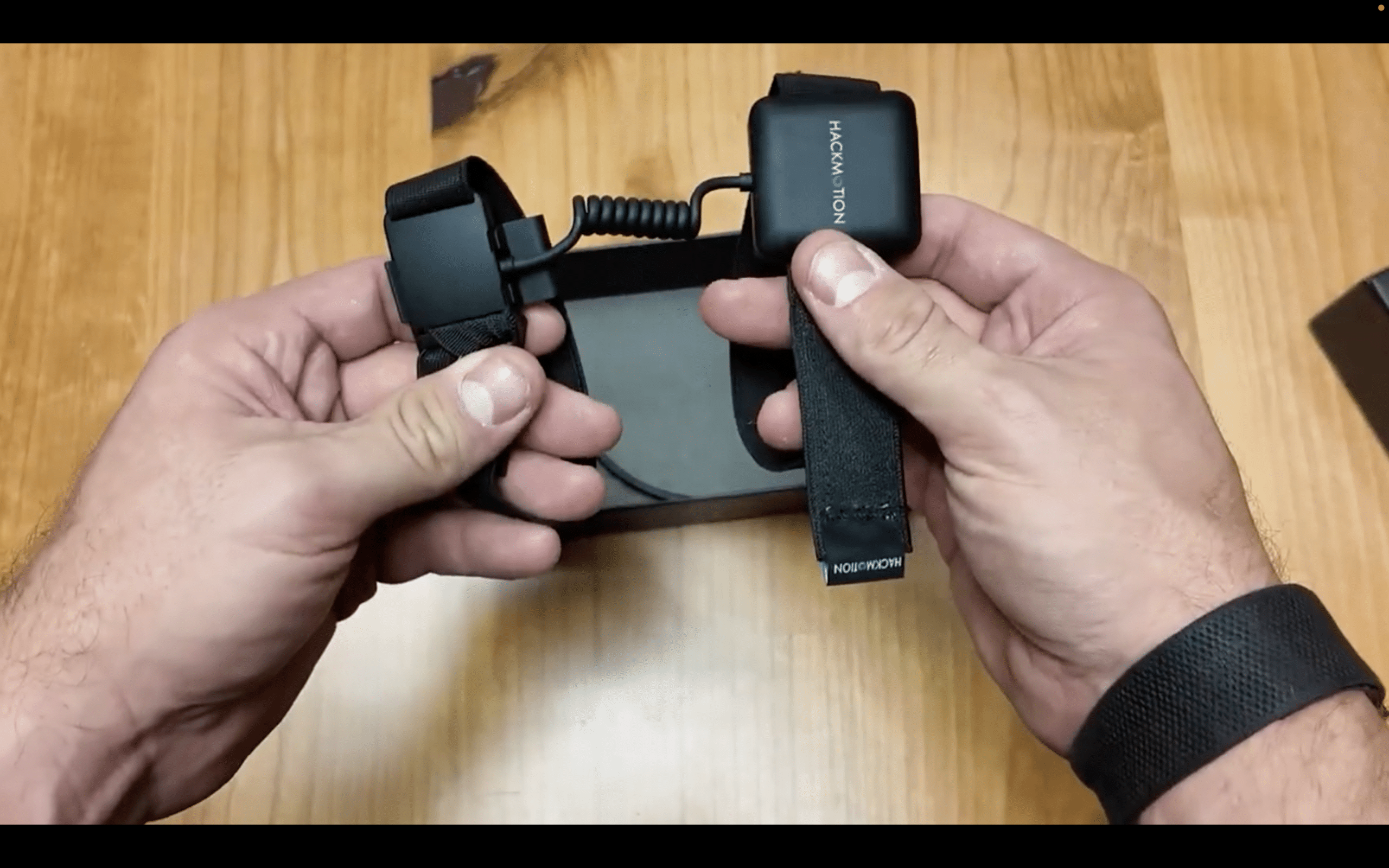 Hands holding HackMotion motion sensor straps