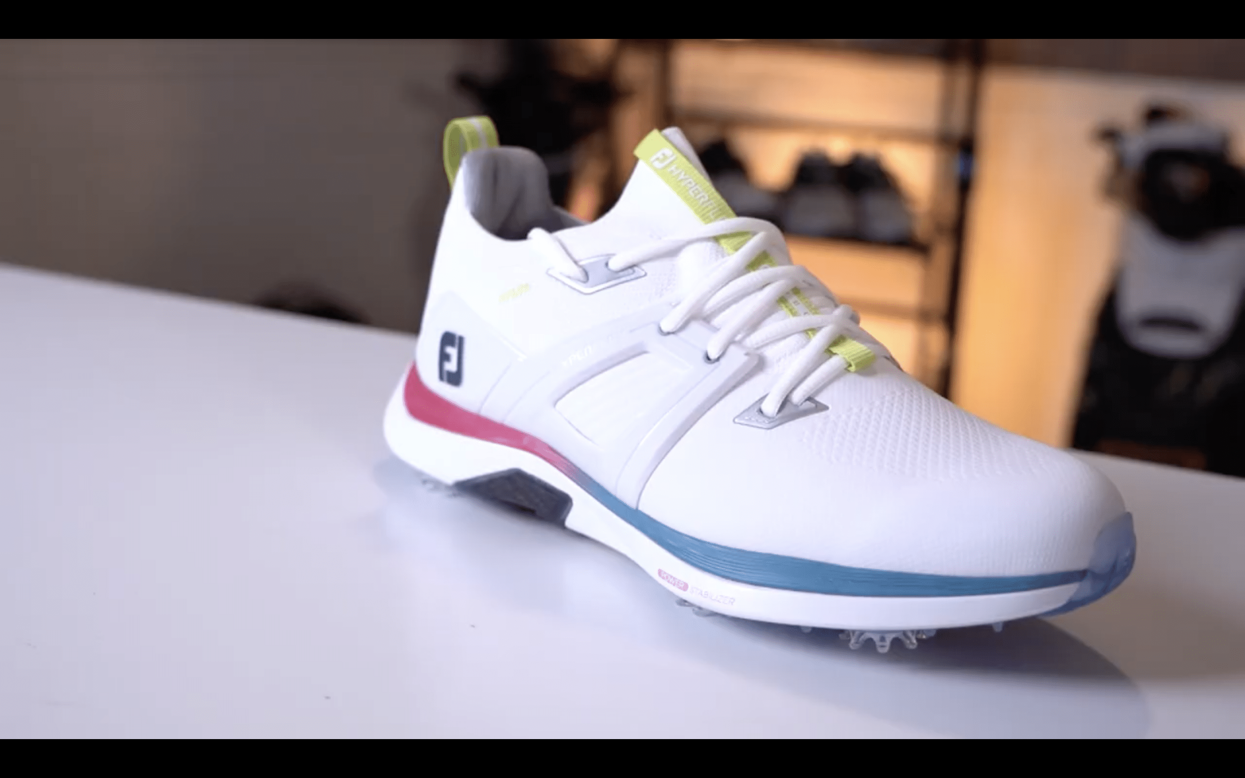 White athletic golf shoe on display table