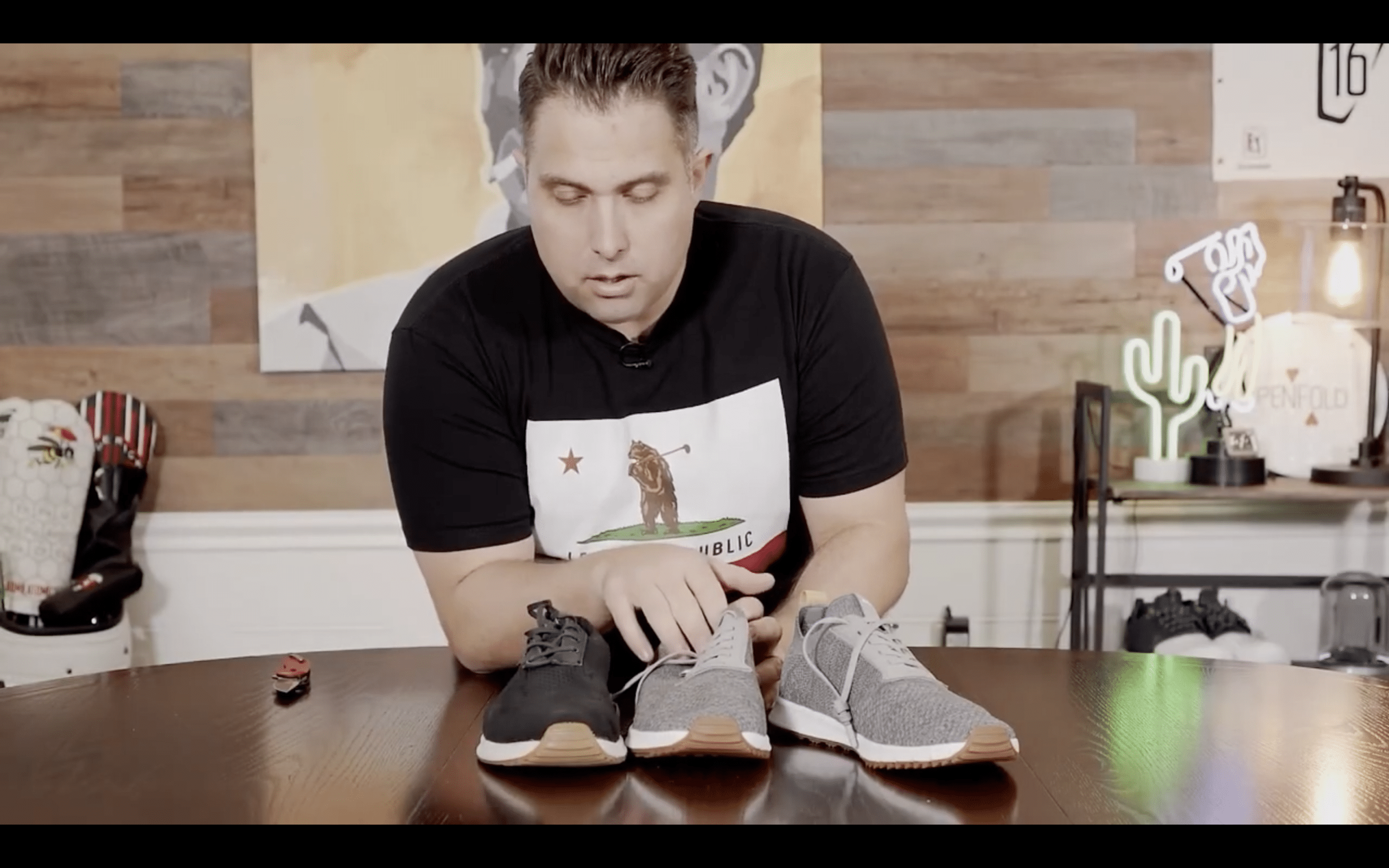 Person comparing three sneakers on a table