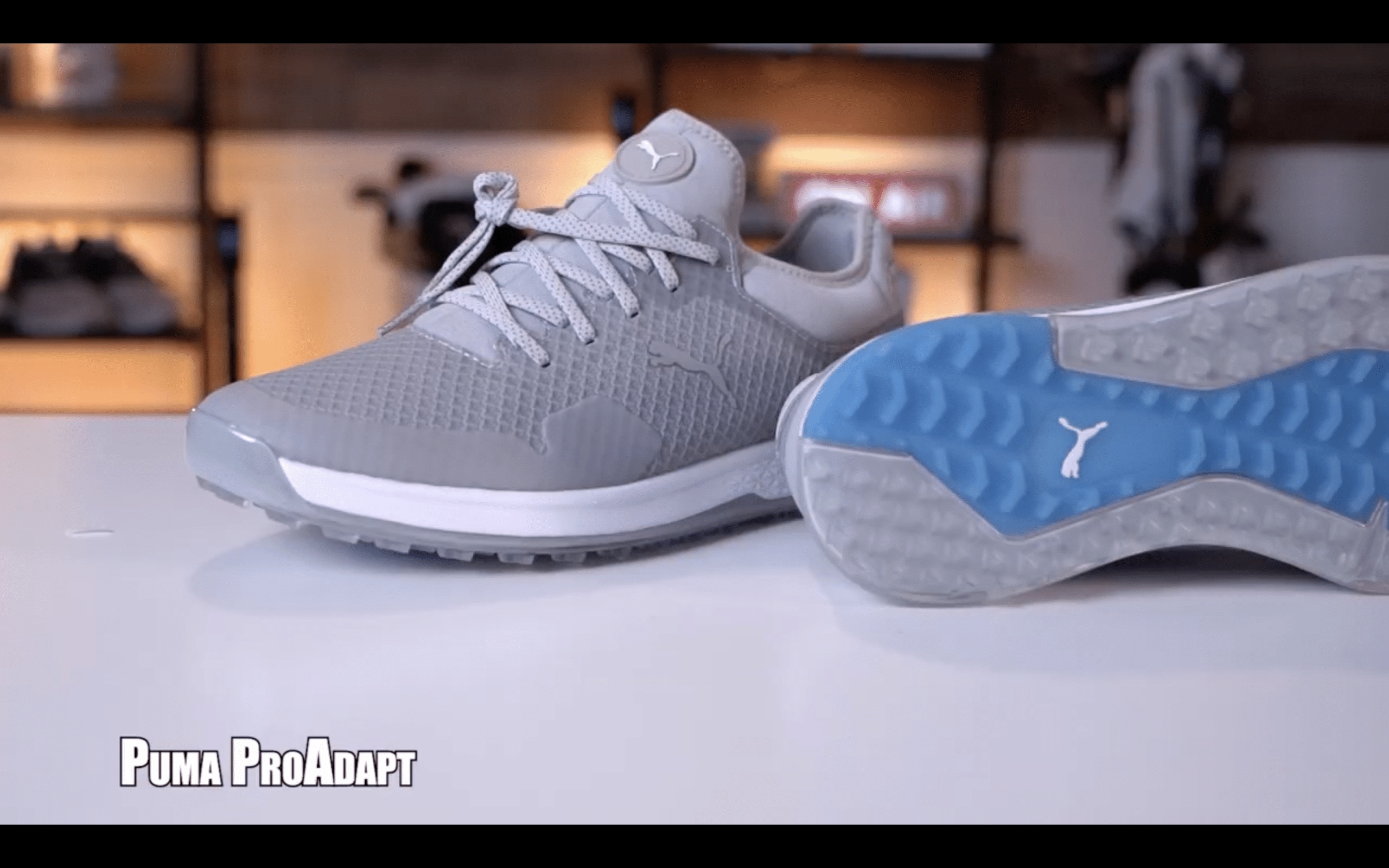 Gray Puma ProAdapt golf shoes on display