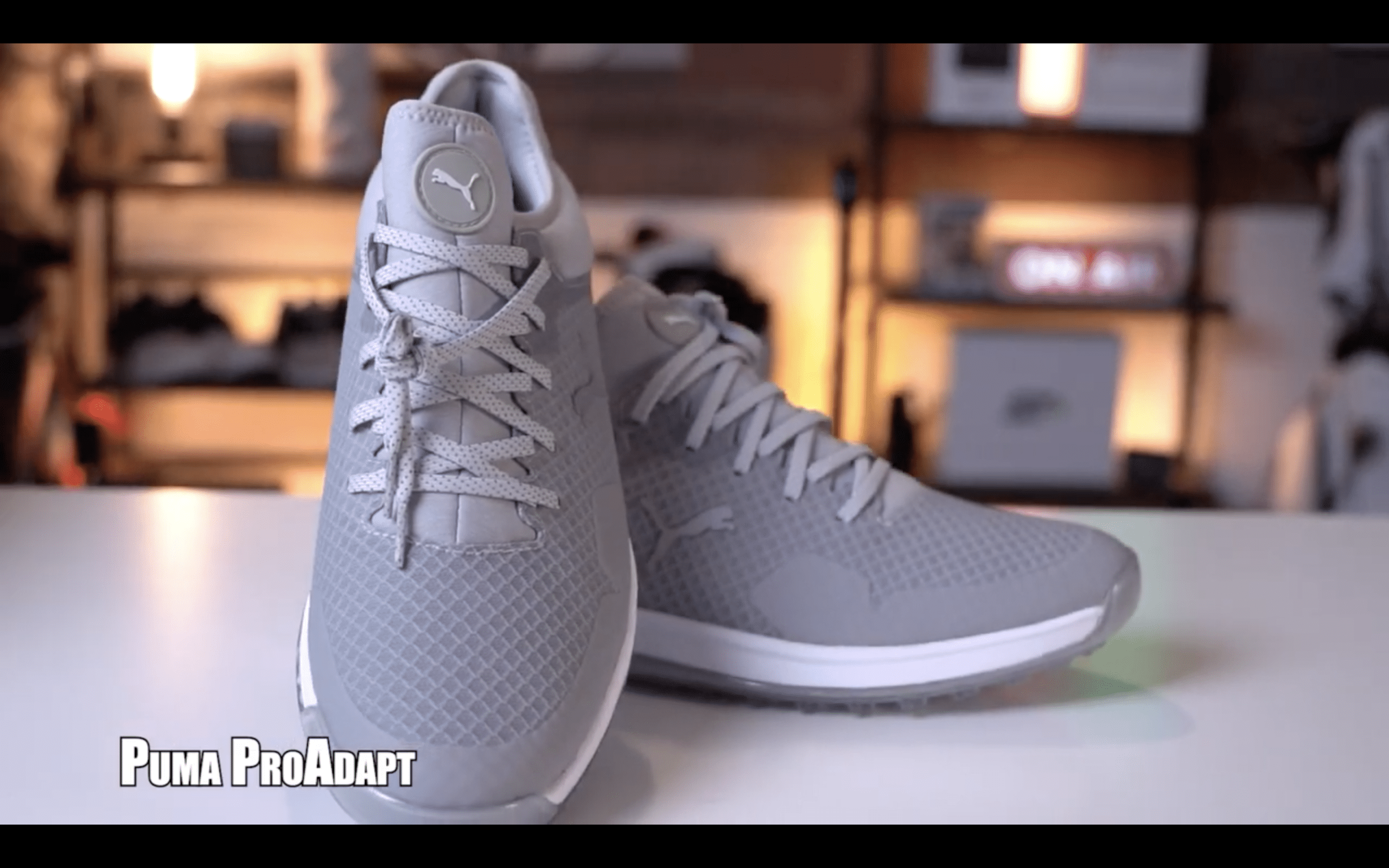 Gray Puma ProAdapt athletic shoes on display table