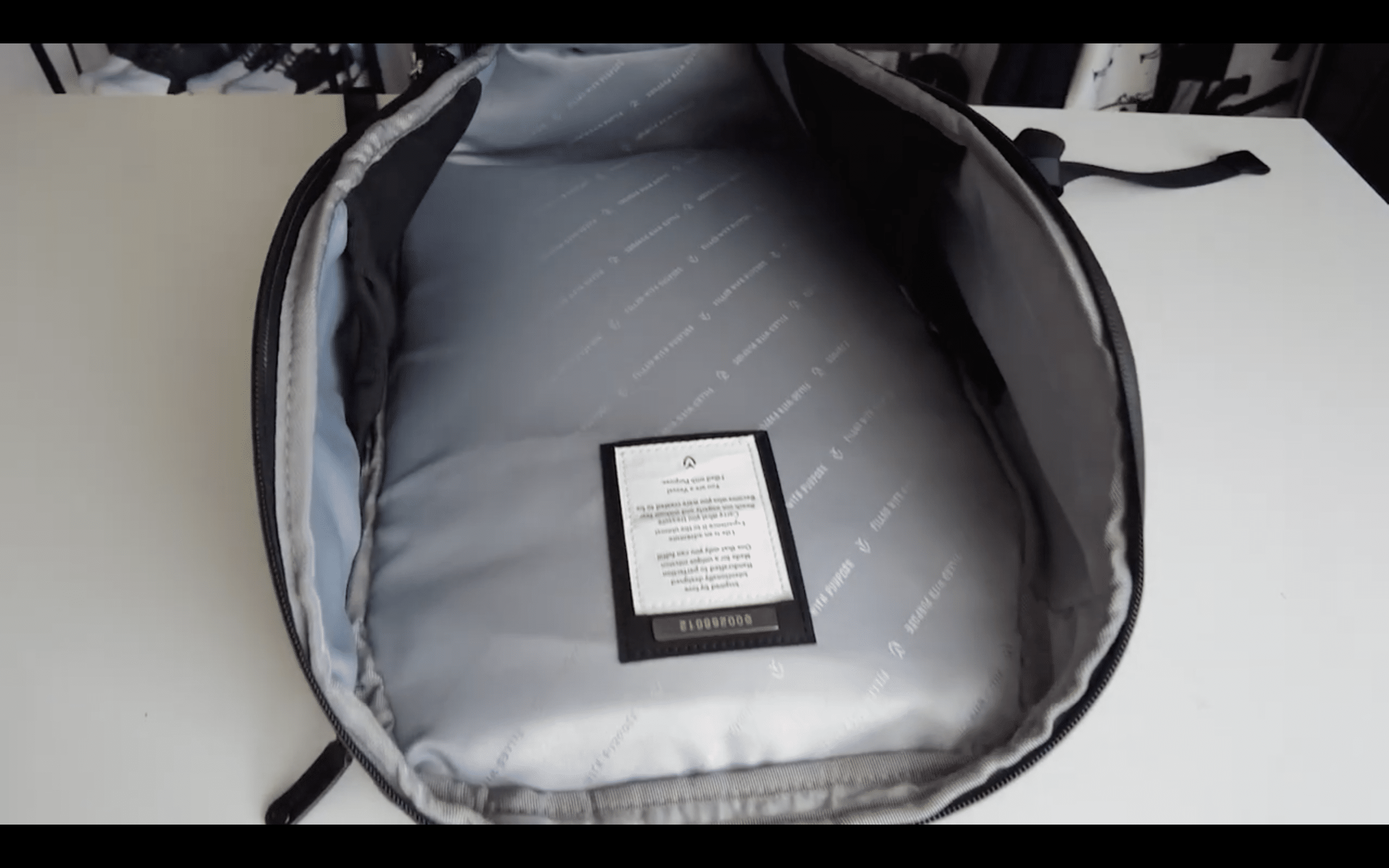 Open empty gray backpack interior on table