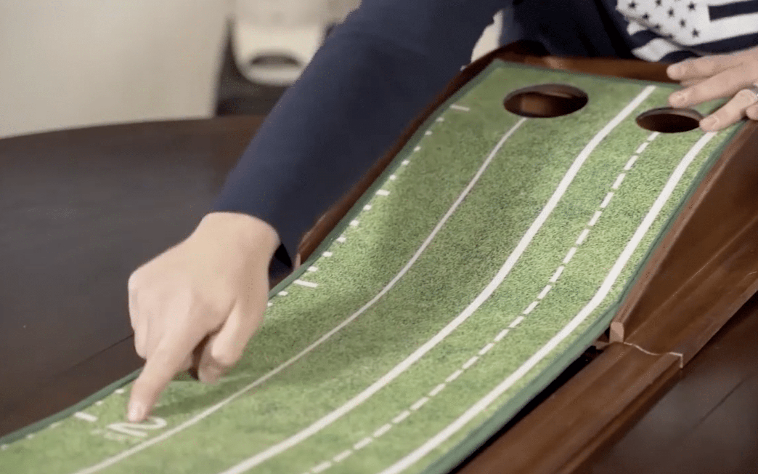 Person pointing at tabletop football game board