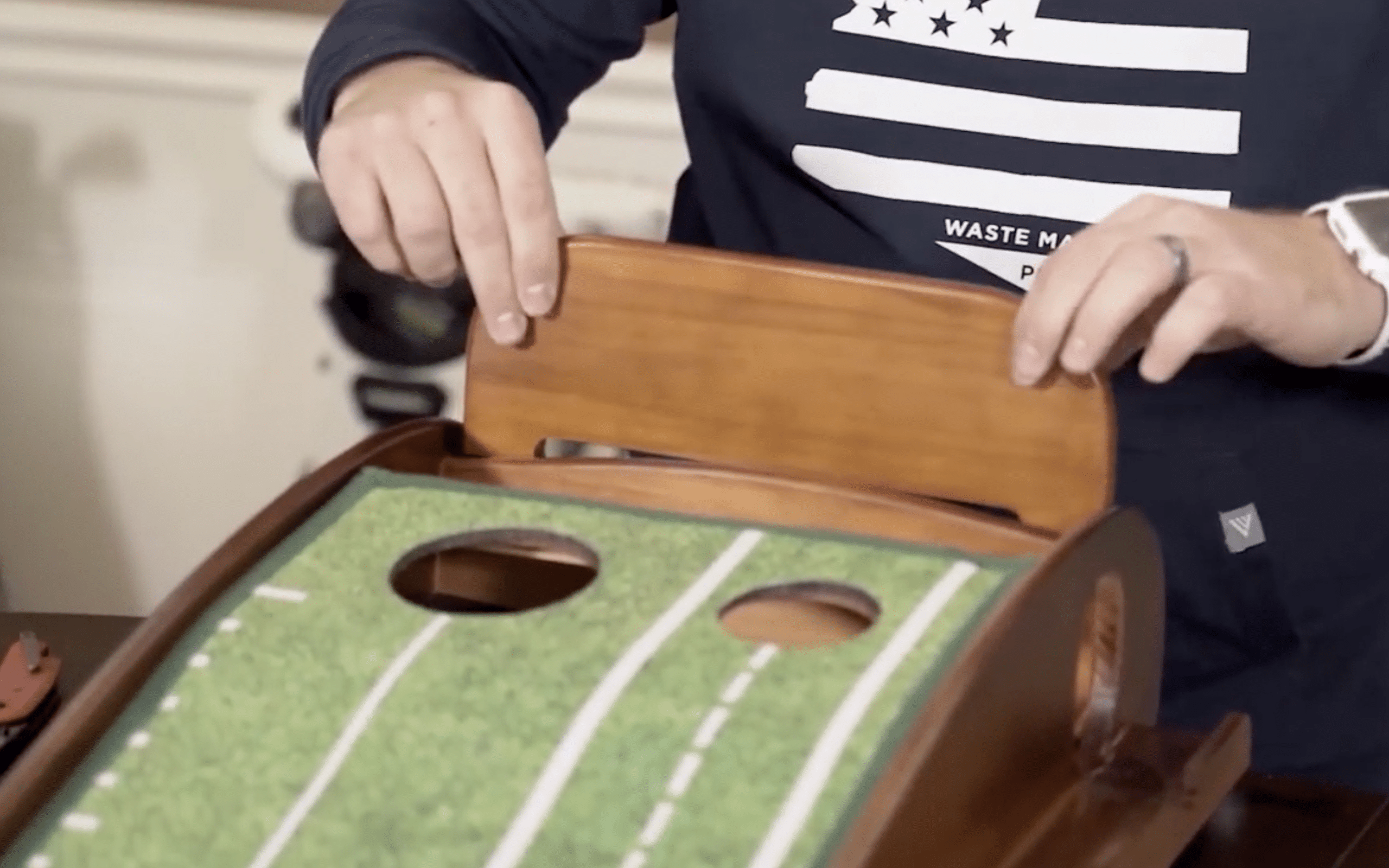 Person assembling tabletop cornhole game.