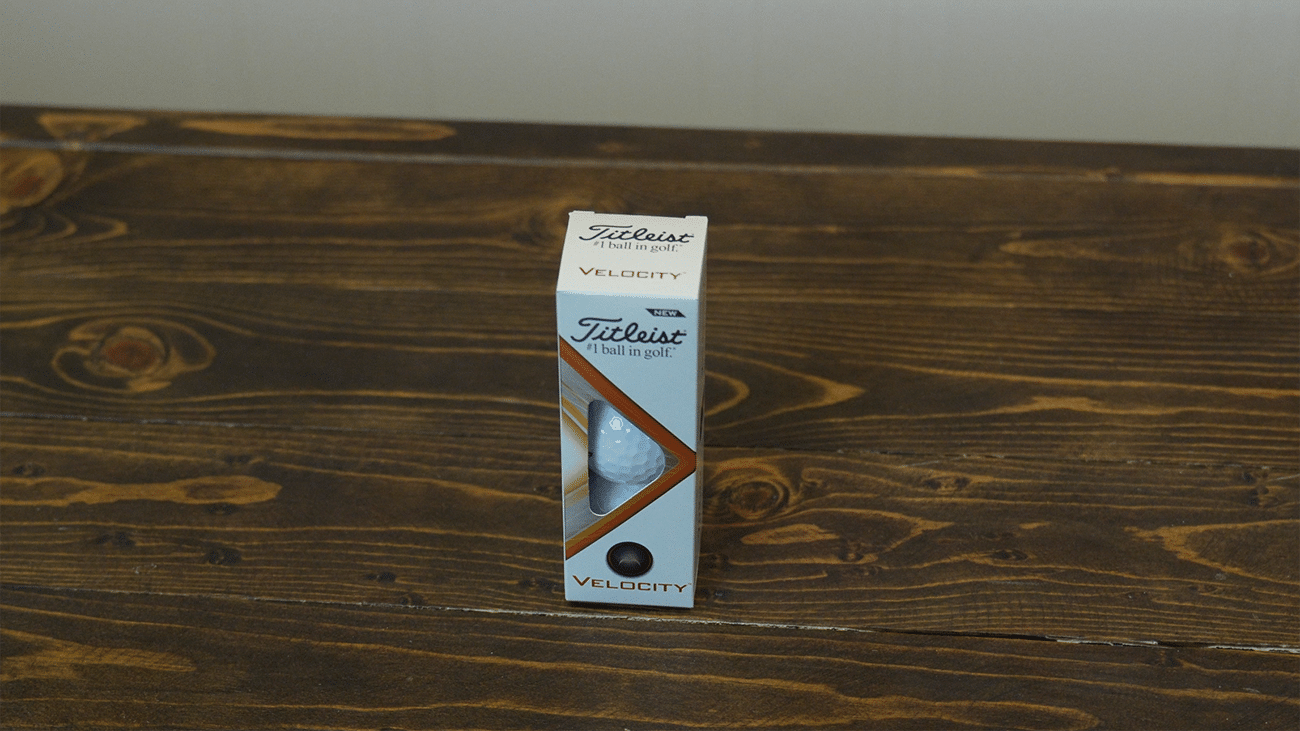 Titleist Velocity golf ball box on wooden table